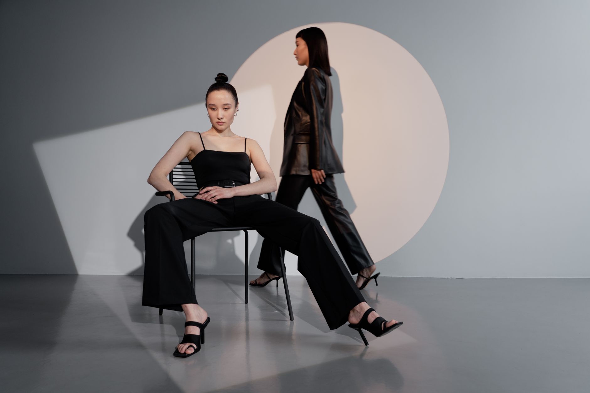Editorial fashion image showing structured harness silhouette with clean hardware detailing