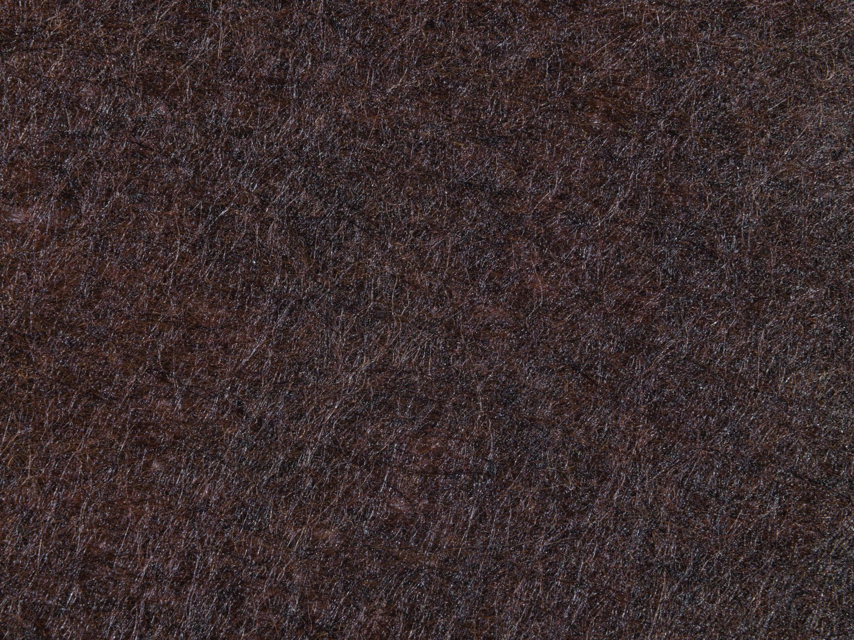 Close-up of warm tan suede fabric texture showing soft nap and surface detail