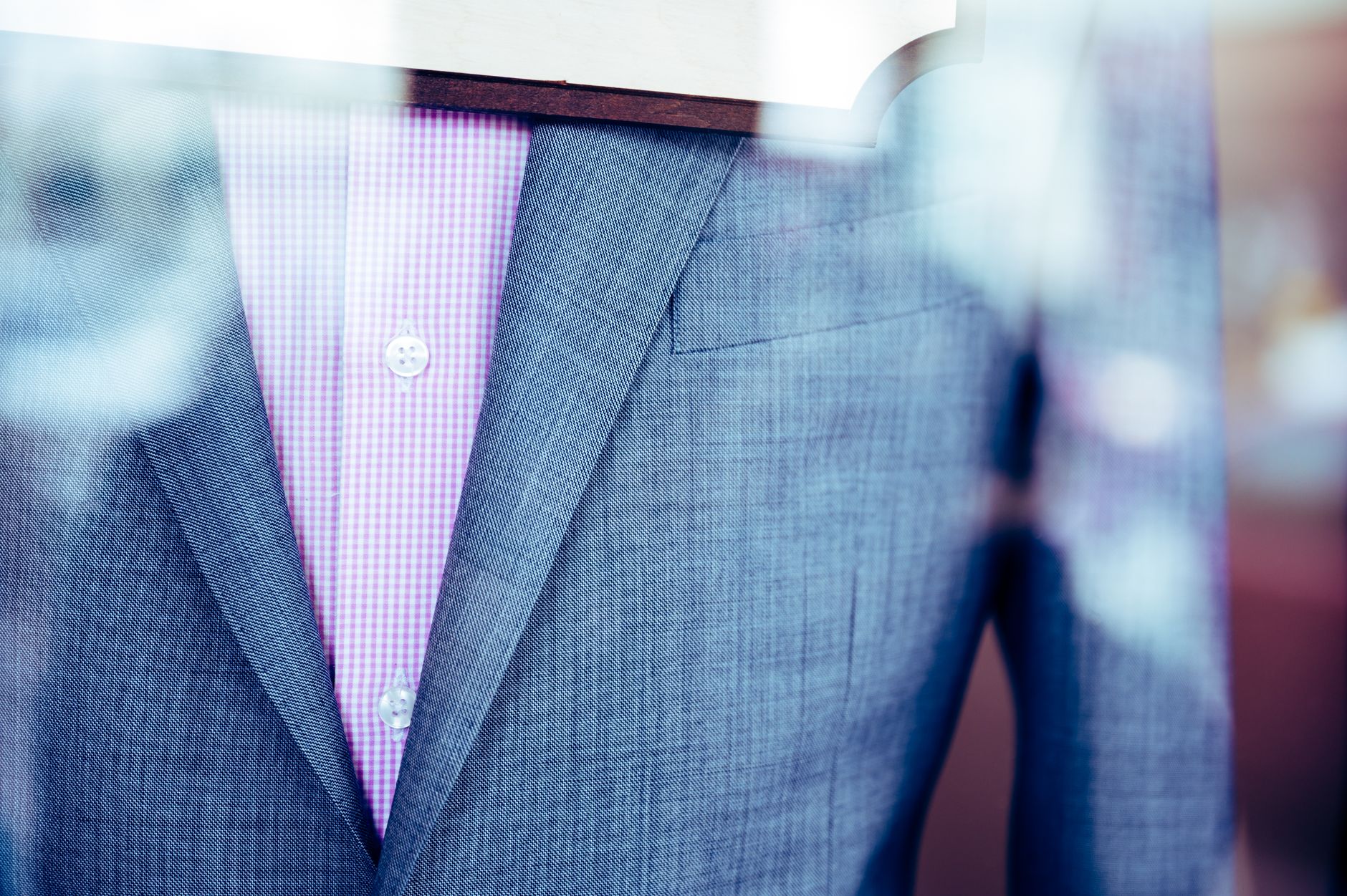 Fine wool trouser with contrasting leather panel seam in a tailoring atelier setting