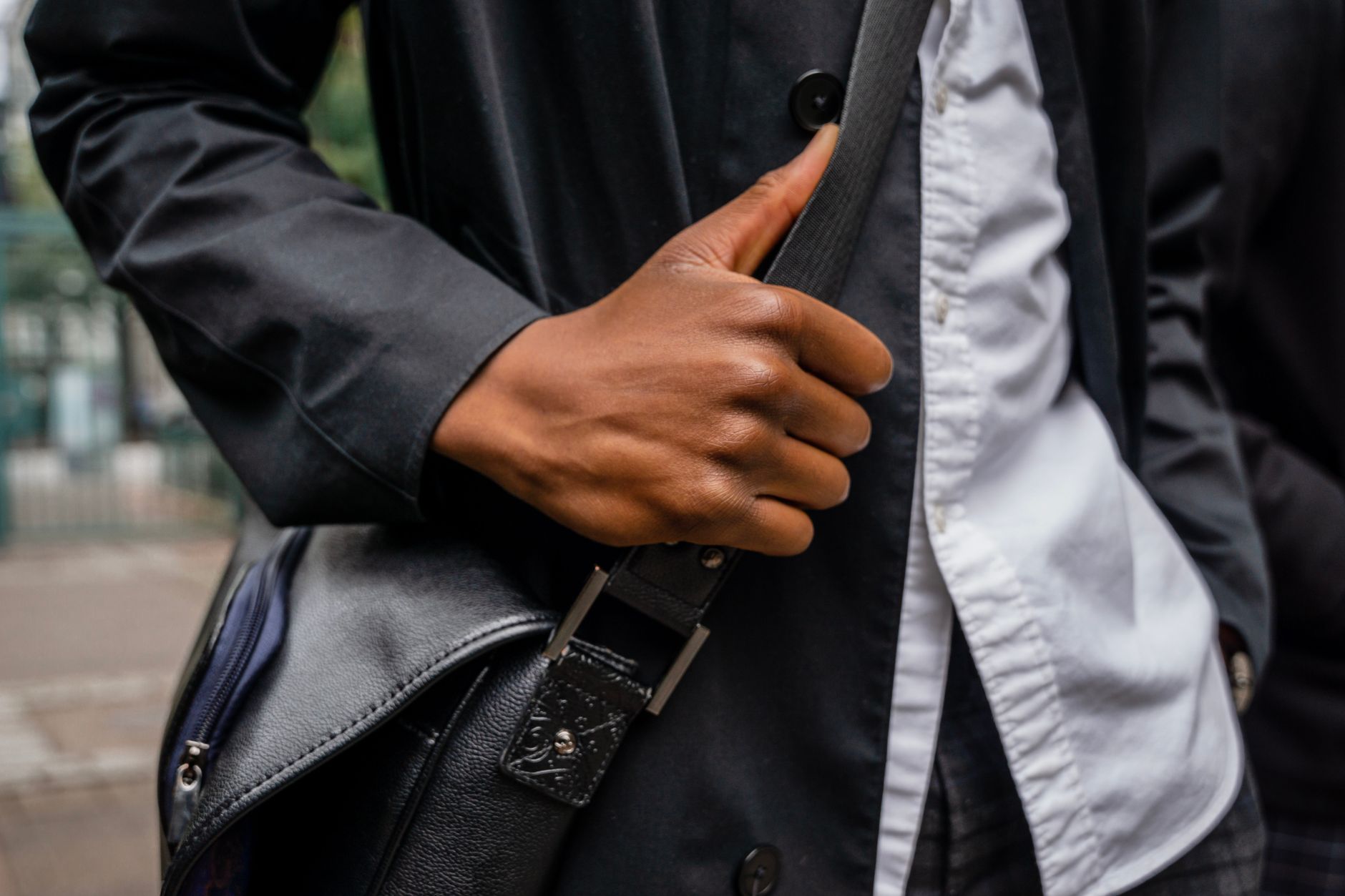 Close-up of saddle stitching and hardware detail on a structured leather skirt panel