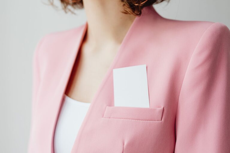 Close-up of a structured blazer shoulder seam showing a rounded, shaped sleeve head