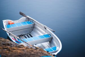 Close-up of rowing club boat hardware fittings along the loom rail