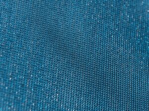Close-up of a shimmering metallic woven fabric with a tight, structured weave pattern