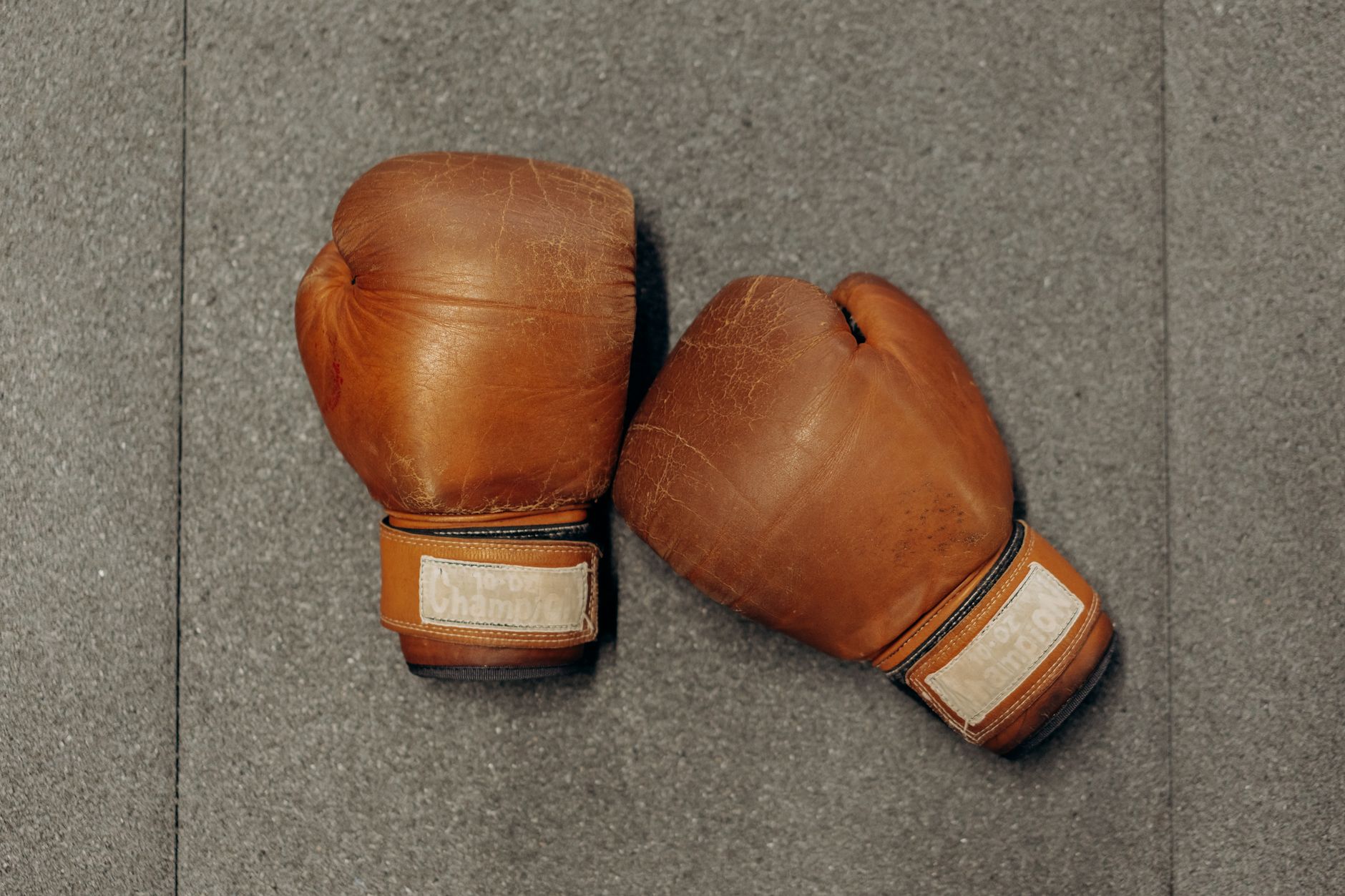 Pair of structured leather gloves with flared cuff detail on a neutral background