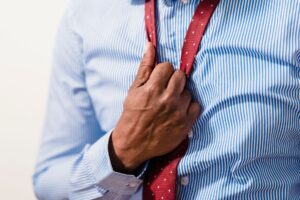 Close-up of a structured formal dress shirt collar with crisp white fabric and precise collar stand construction