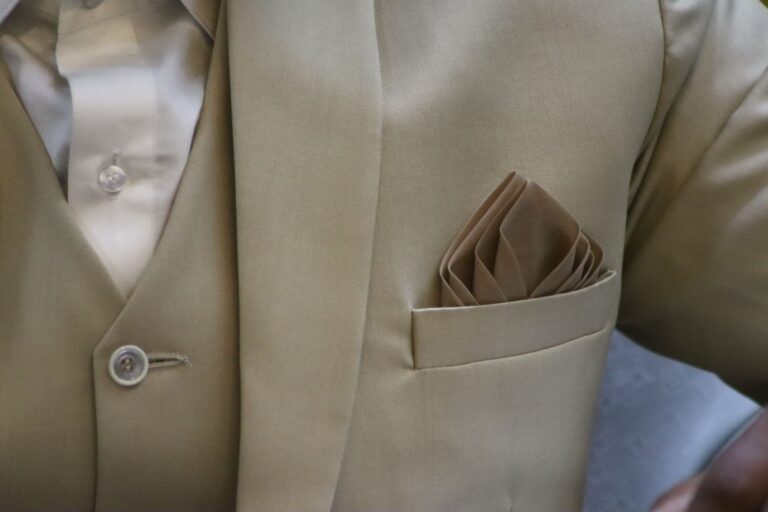 Close-up of a structured blazer lapel showing silk edge finishing detail