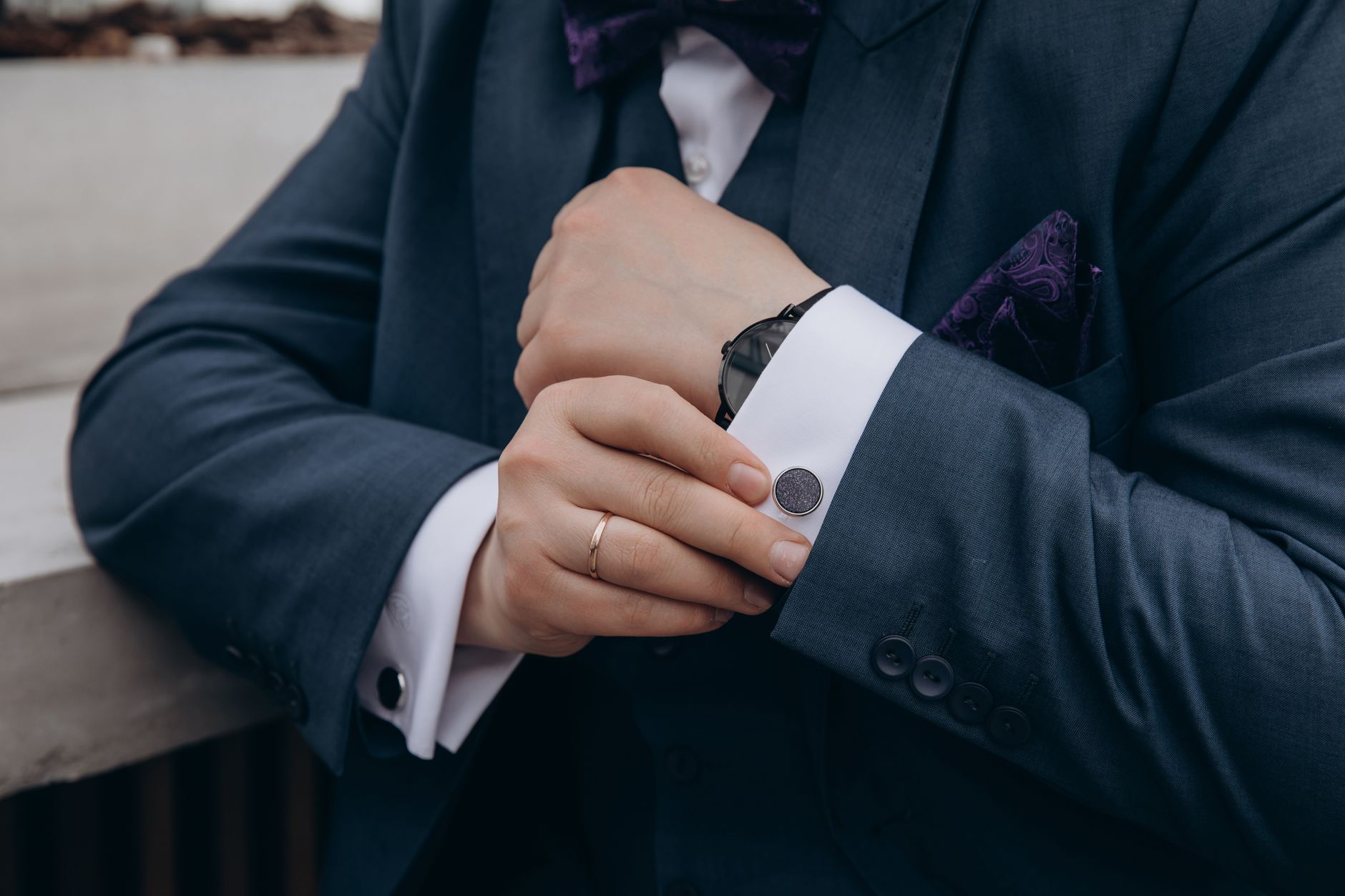 Close-up of a tailored suit jacket sleeve showing uniform button placement along the cuff edge