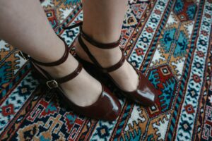Close-up of a narrow leather ankle strap with a simple buckle fastening against a clean background