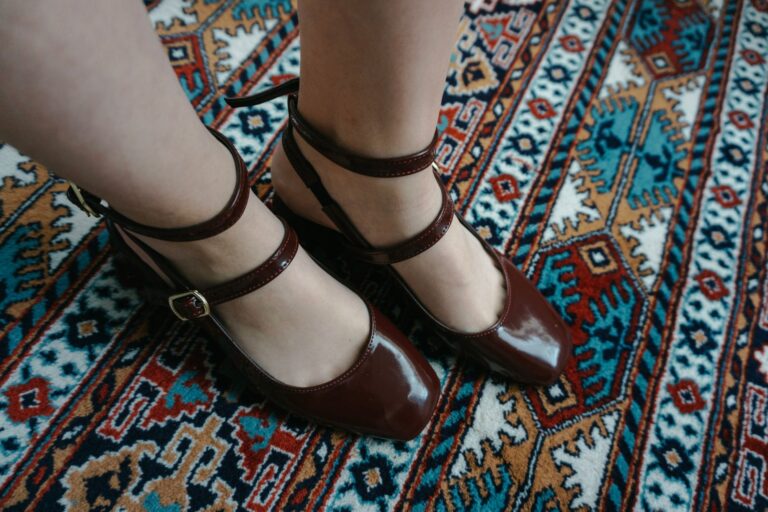 Close-up of a narrow leather ankle strap with a simple buckle fastening against a clean background