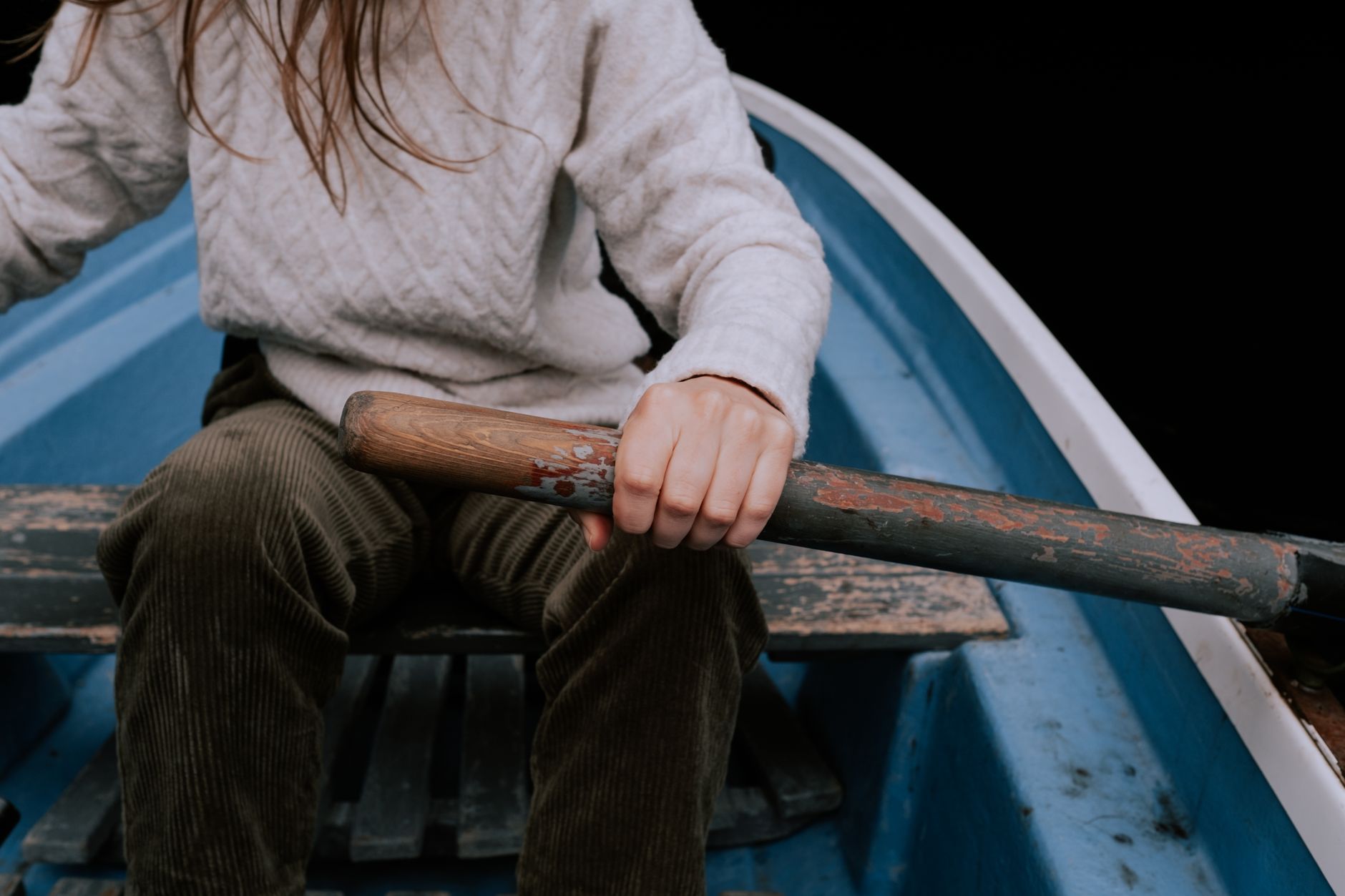 Close-up of traditional wooden rowing boat hardware and oarlock fittings