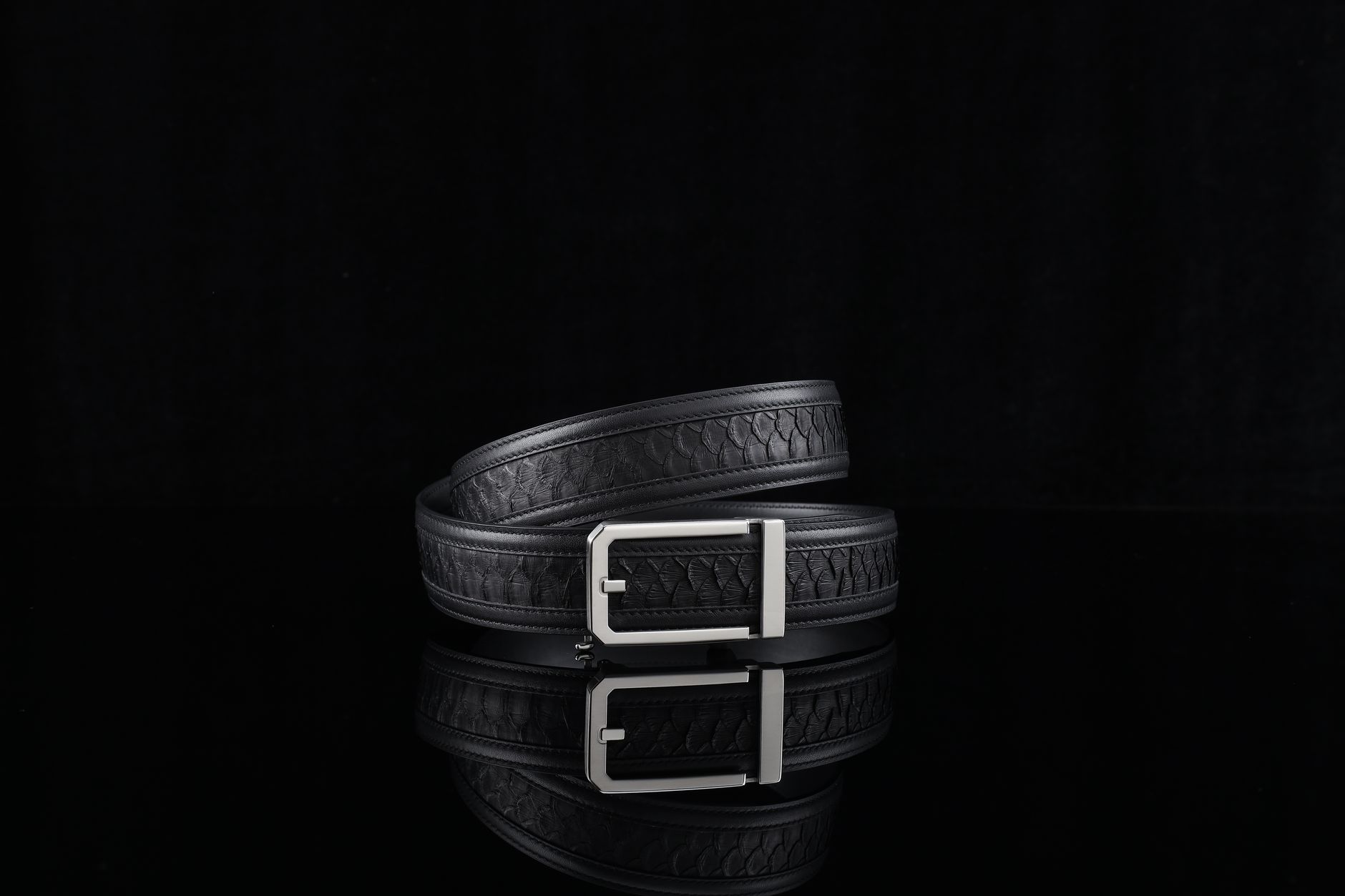 Detailed shot of a metal slider buckle on a leather accessory strap