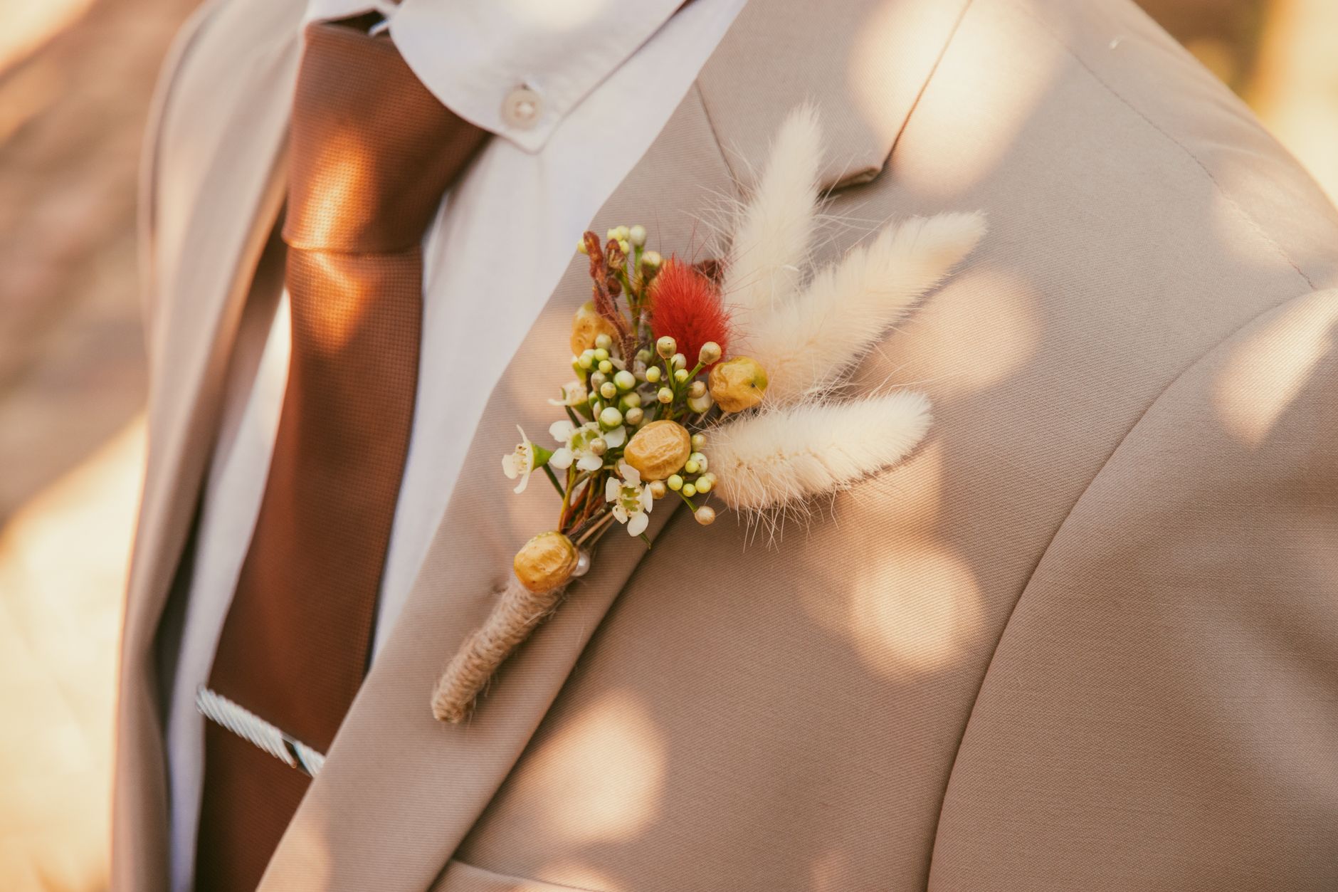 Detail shot of a tailored blazer back panel with a contrast button at the base of the rear vent