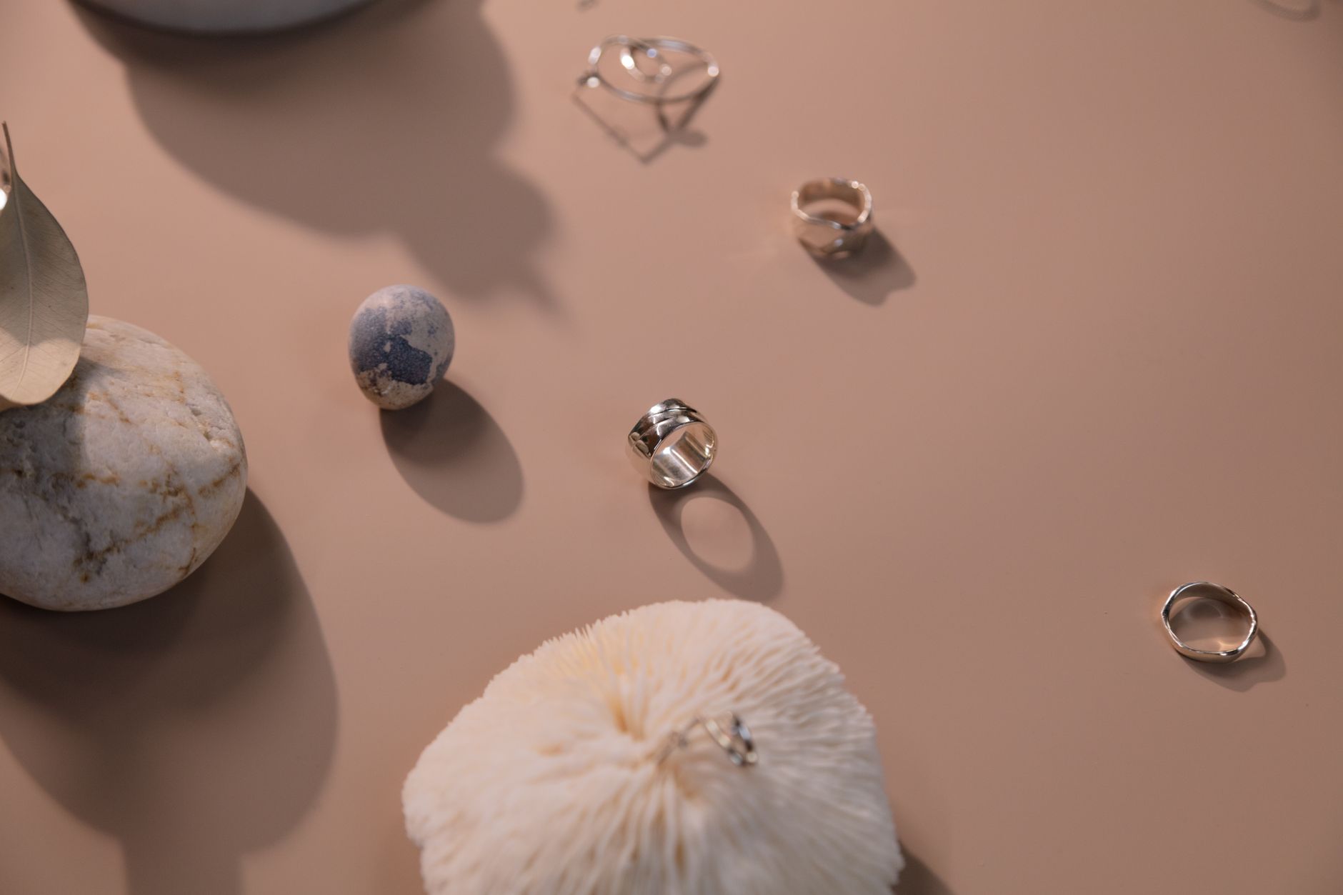Flat lay of multiple chain necklaces in varying widths and metal finishes arranged for layering