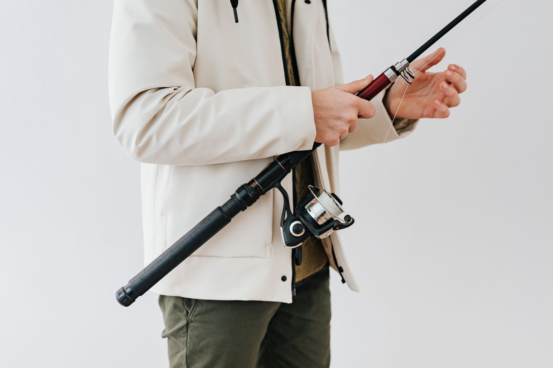 Detail shot of industrial-style bolt hardware on the placket of a minimalist canvas jacket