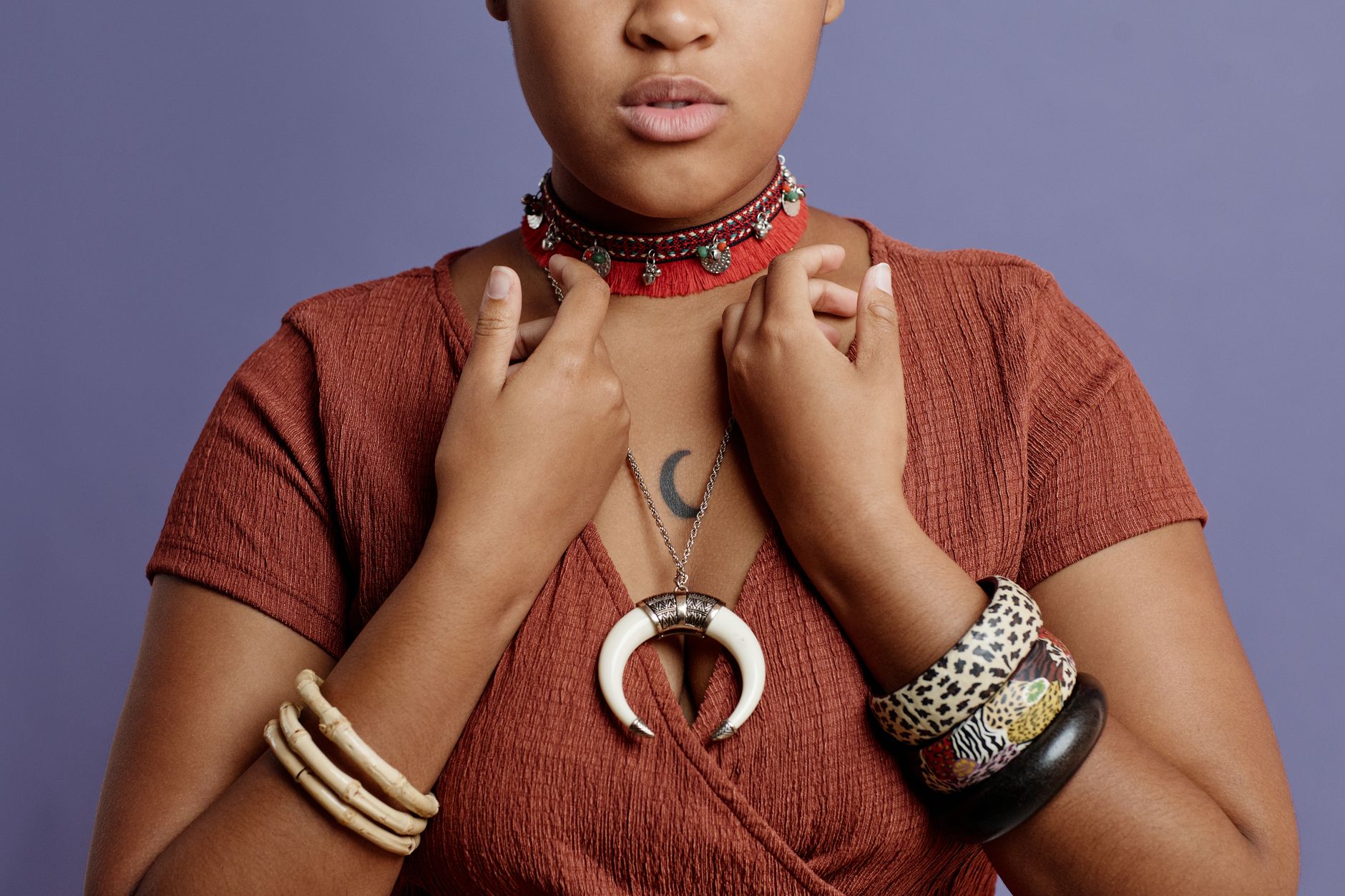 Layered collar necklace stack featuring heavy ring hardware at the sternum