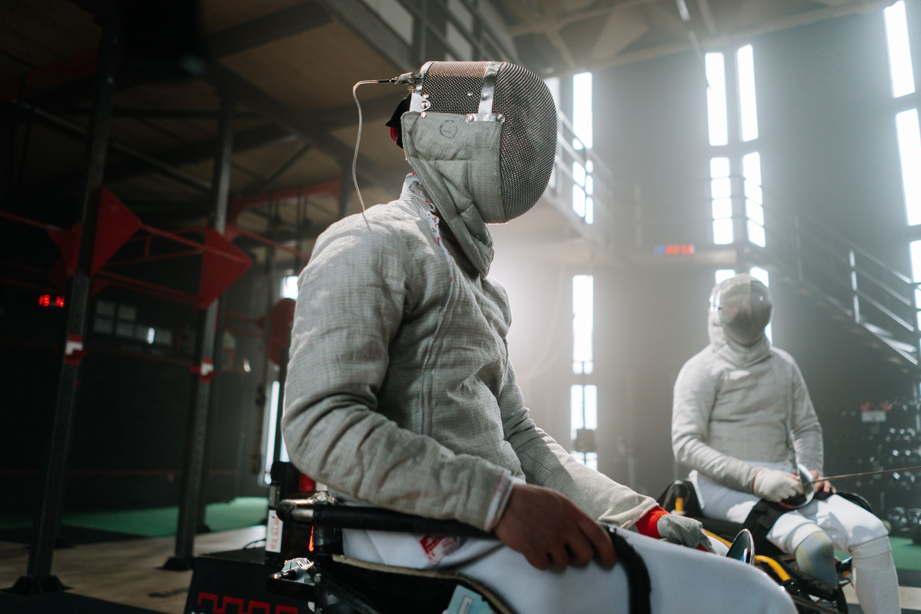 Fencing equipment including metallic lame jacket and mask laid out before a competition