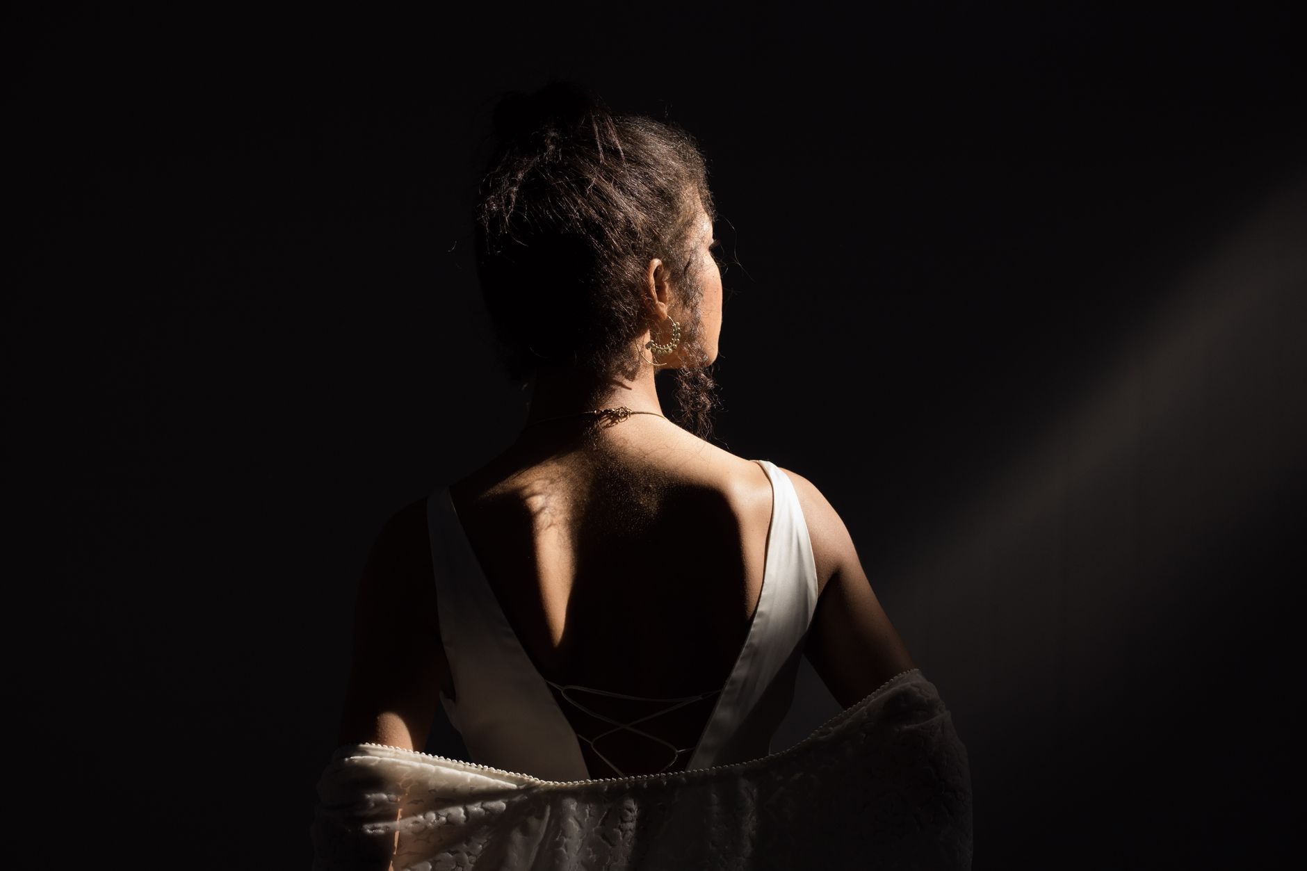 The open back of a formal evening gown showing structured strap detailing