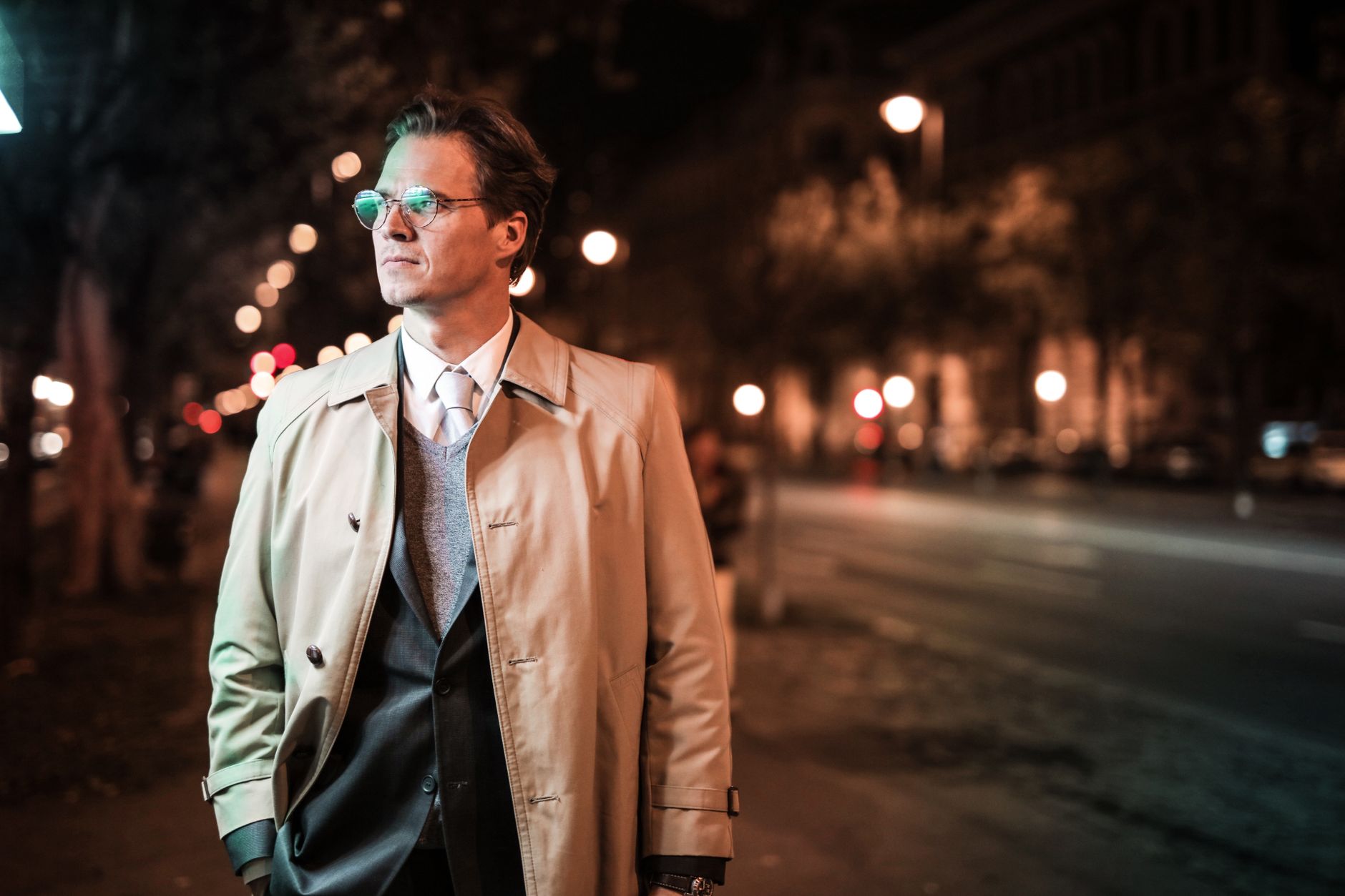 A structured formal evening coat with defined lapel edges on a dressed figure