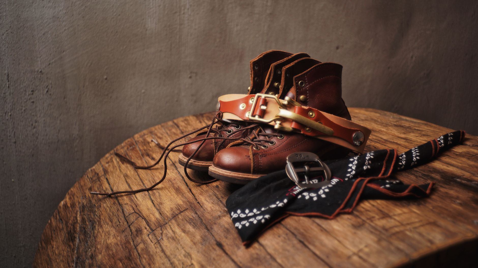 Flat lay of vegetable-tanned leather straps and small rectangular buckles on a neutral surface