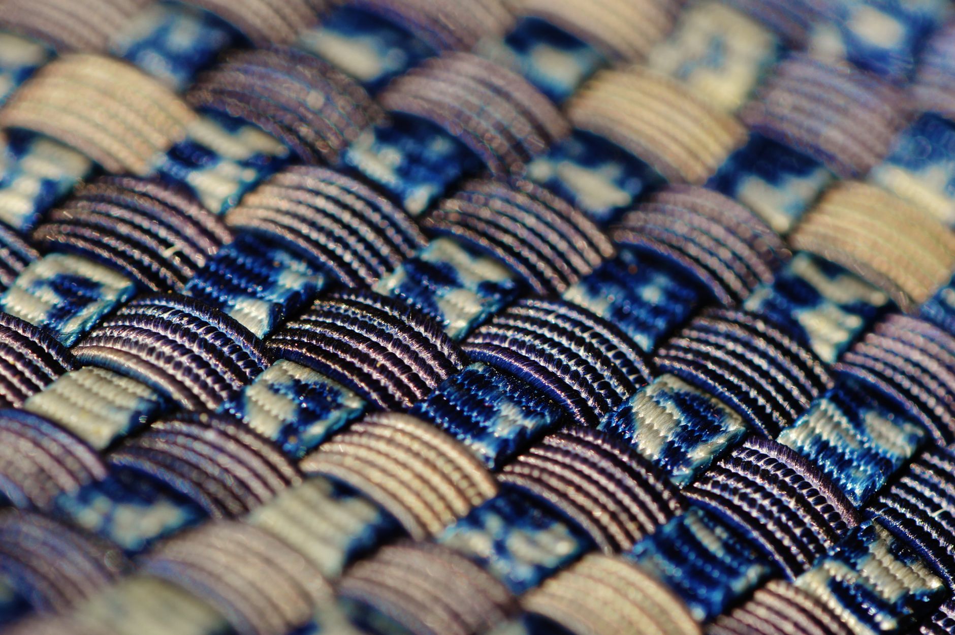 Close-up of flat braided cord wrapped and knotted, showing layered textile structure