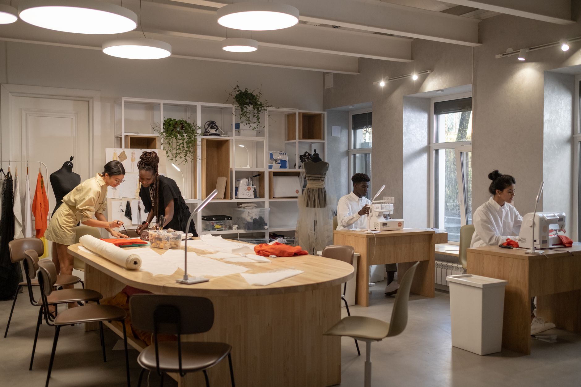 Fashion design workshop with structured garments and construction materials on a worktable