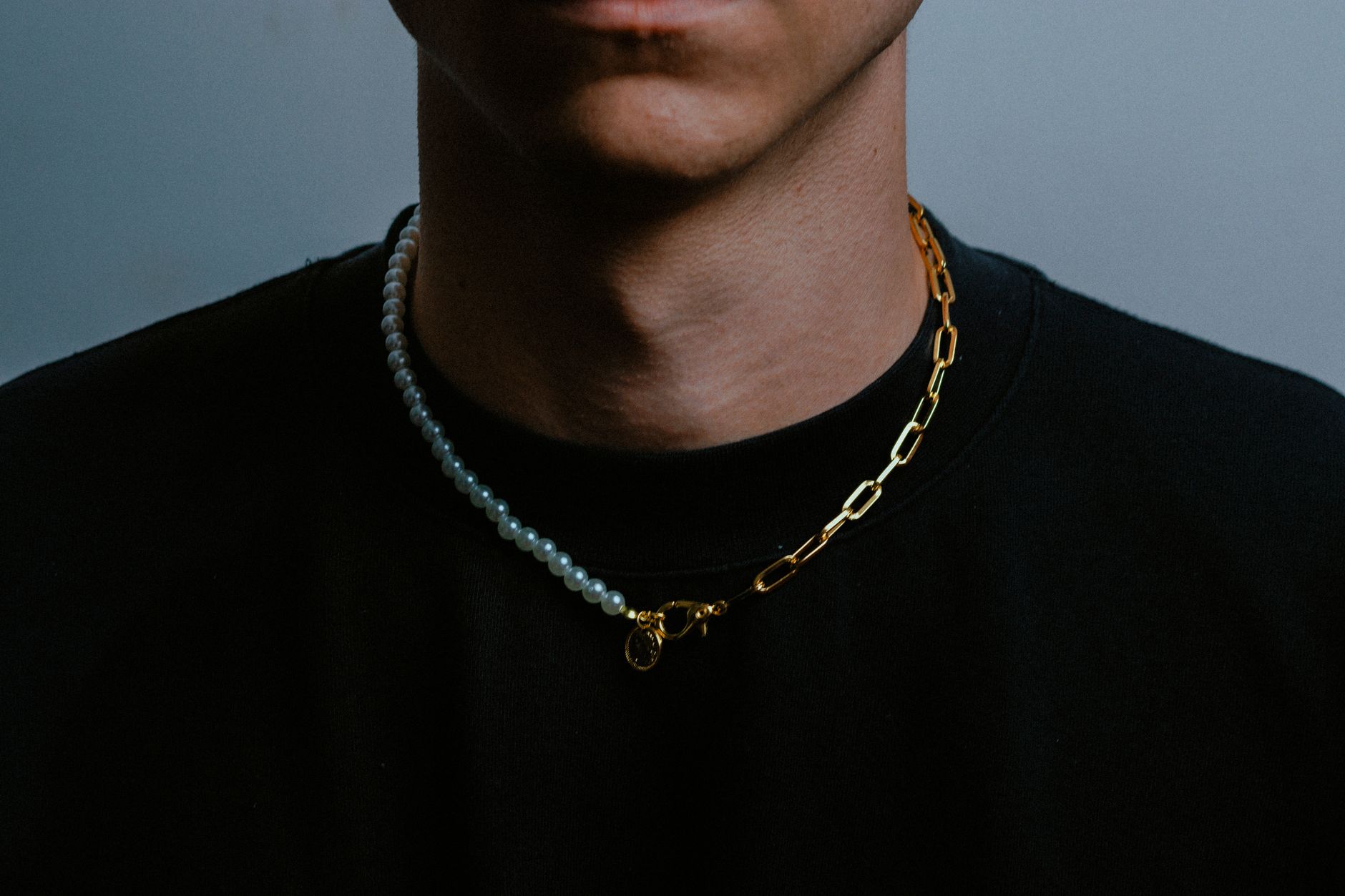Close-up detail of a flat metal clasp on a minimalist choker accessory