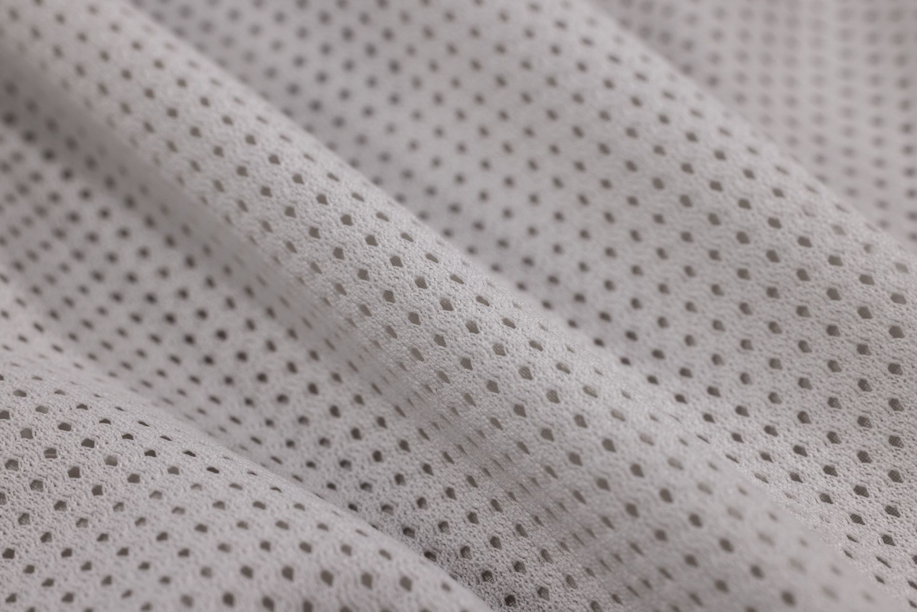 Detail shot of woven binding trim applied along the edge of structured garment fabric