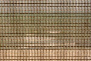 Close-up of industrial metal mesh grid panel with geometric pattern