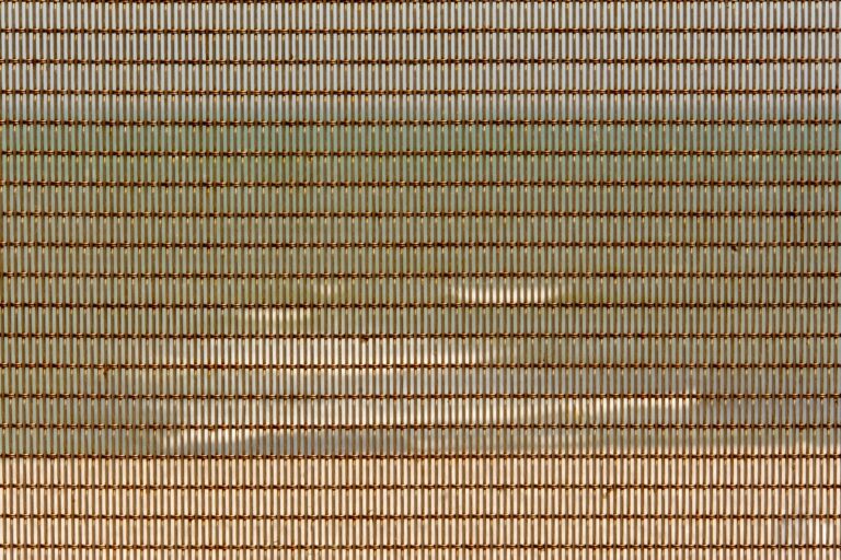 Close-up of industrial metal mesh grid panel with geometric pattern
