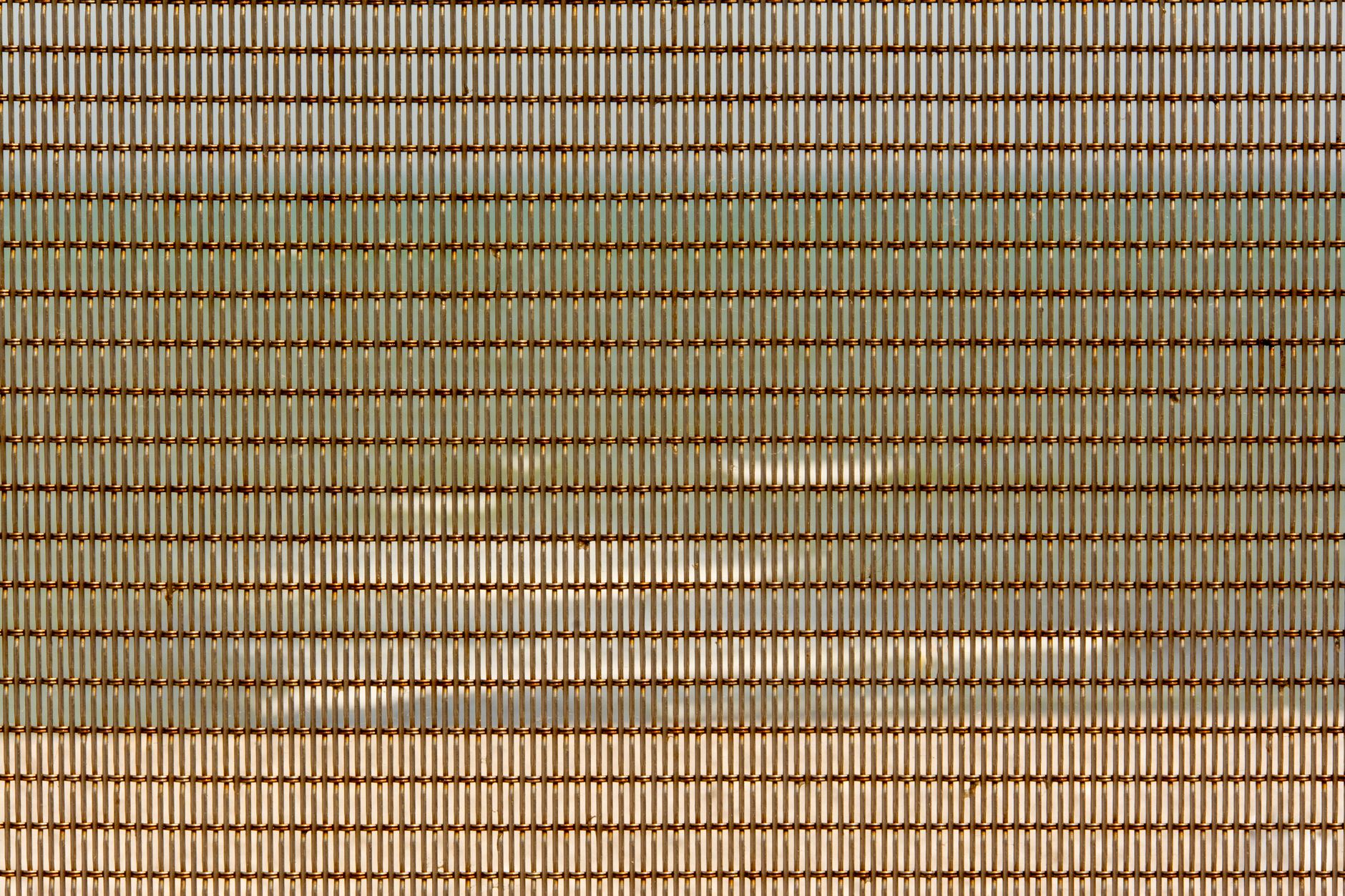 Close-up of industrial metal mesh grid panel with geometric pattern