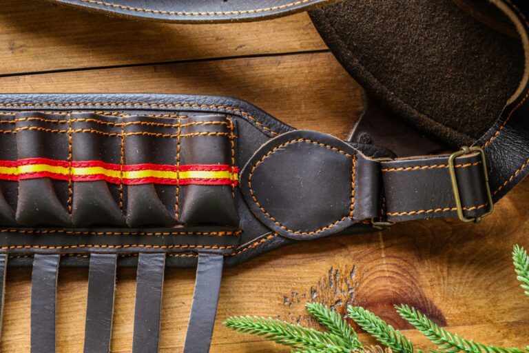 Polo Club Saddle Flap Dee Ring Loops Are Quietly Anchoring Minimalist Belt Hardware Close-up of a minimalist leather belt with metal D-ring hardware on a neutral background