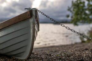 Close-up detail of a rowing shell hull showing structural edging along the gunwale
