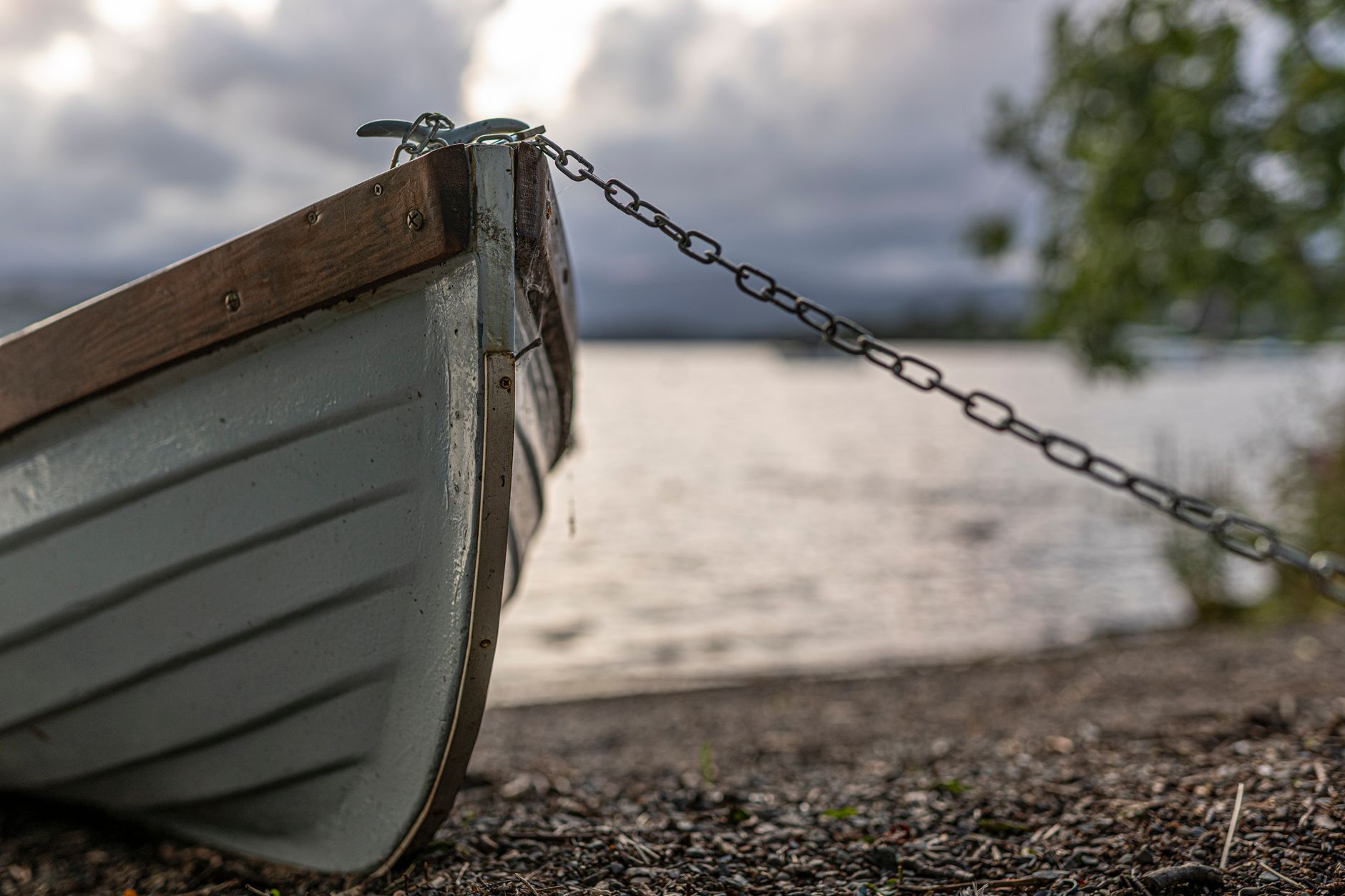 Close-up detail of a rowing shell hull showing structural edging along the gunwale