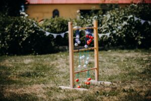 Croquet Mallet Yard Line Chalk Is Quietly Bleaching Washed Denim Hems Croquet mallets and chalk markings on a green garden lawn on a sunny afternoon