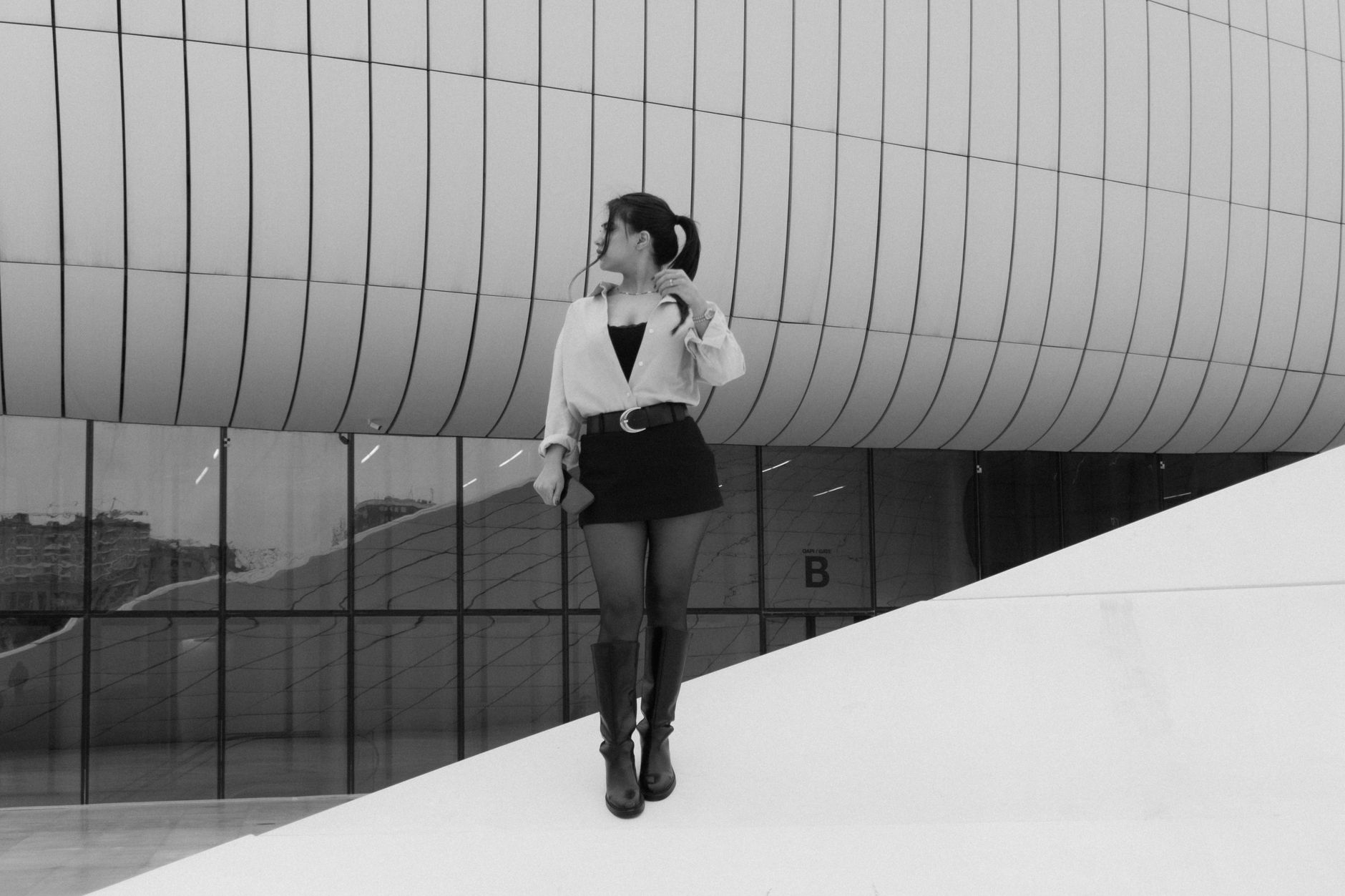 Rear view of a structured womenswear skirt with a clean center-back seam and controlled vent pleat