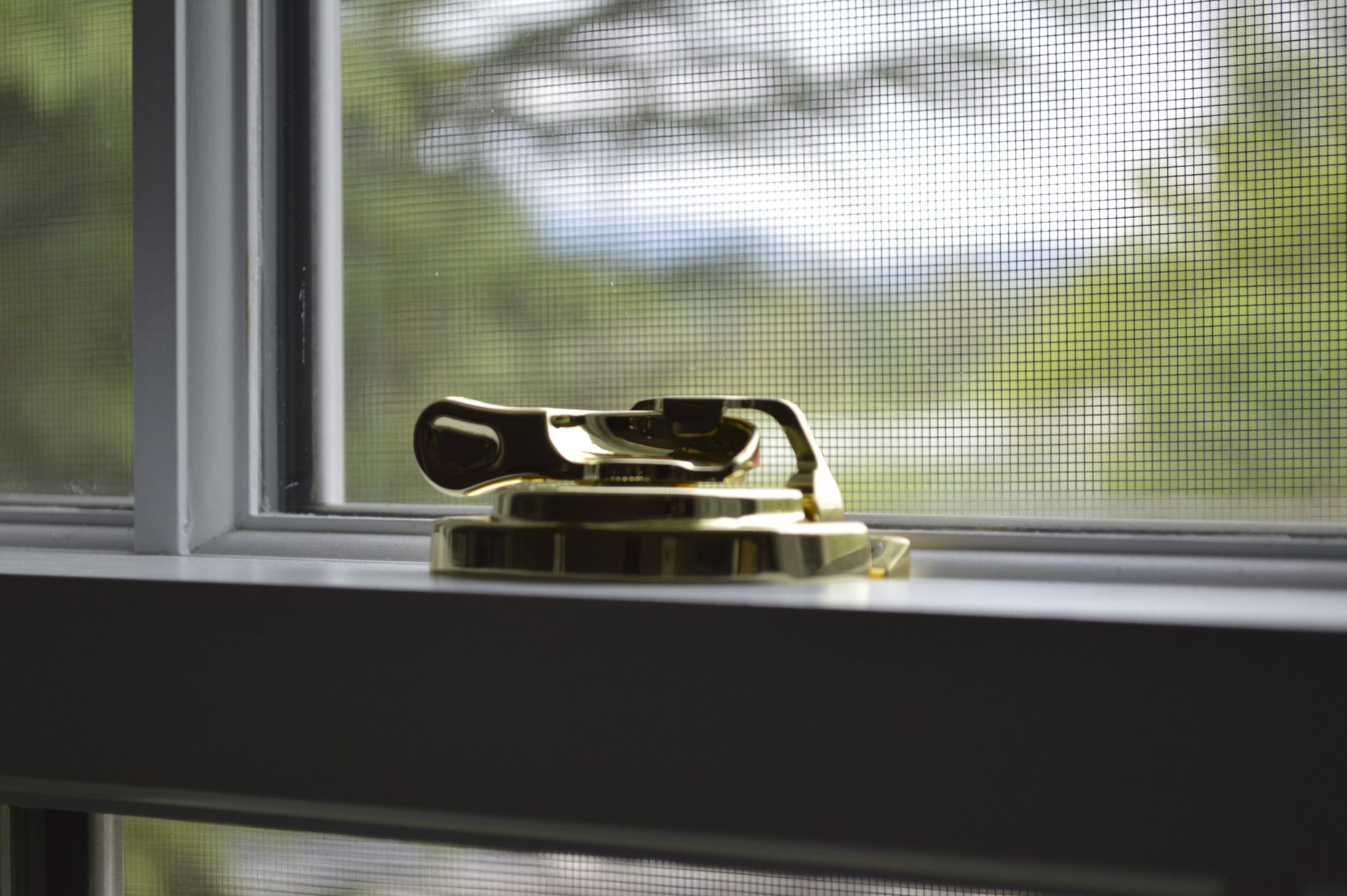 Polished brass metal grommets on fabric textile, showing fine hardware craftsmanship