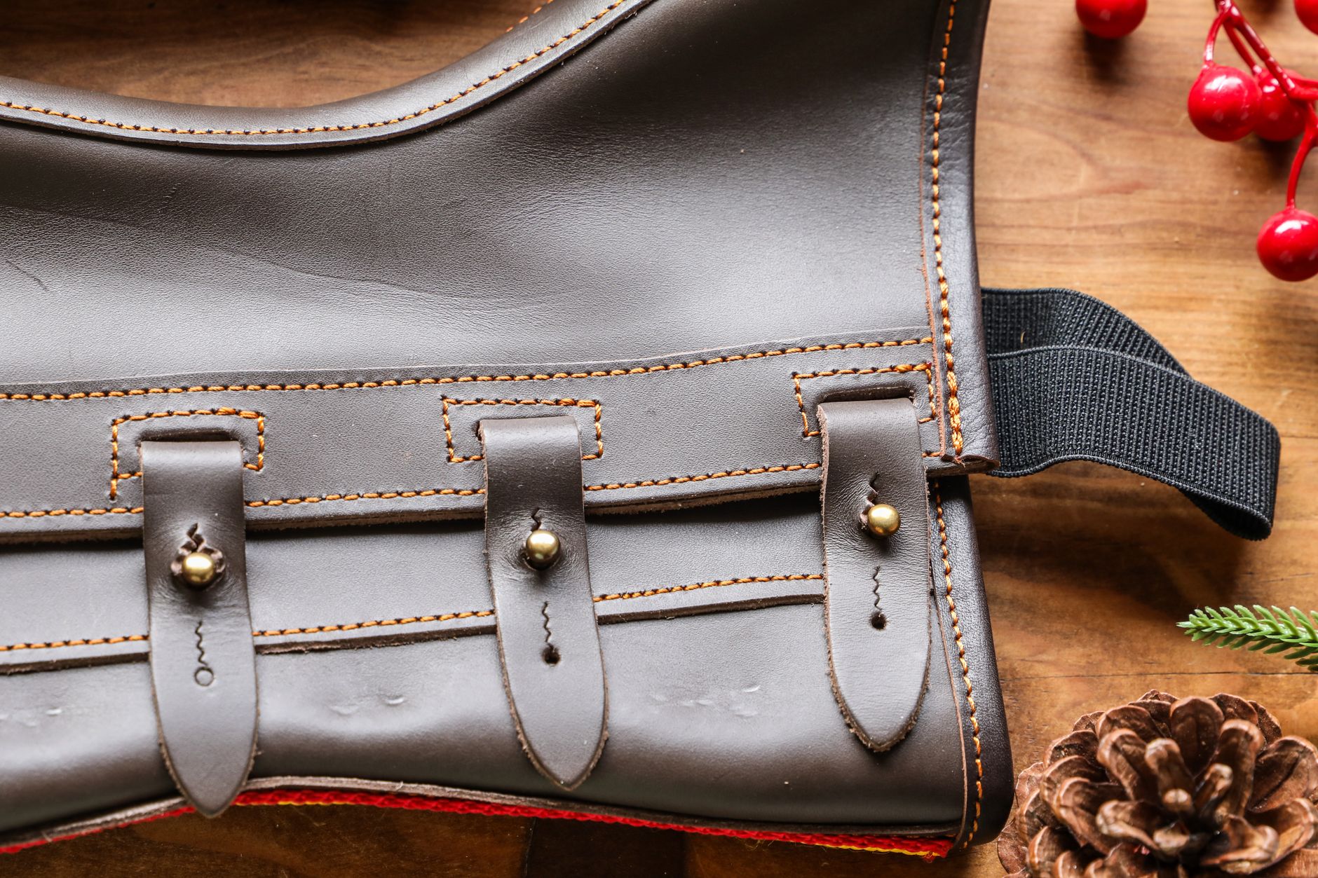 Detail shot of close-set metal eyelets on a dark leather ankle boot