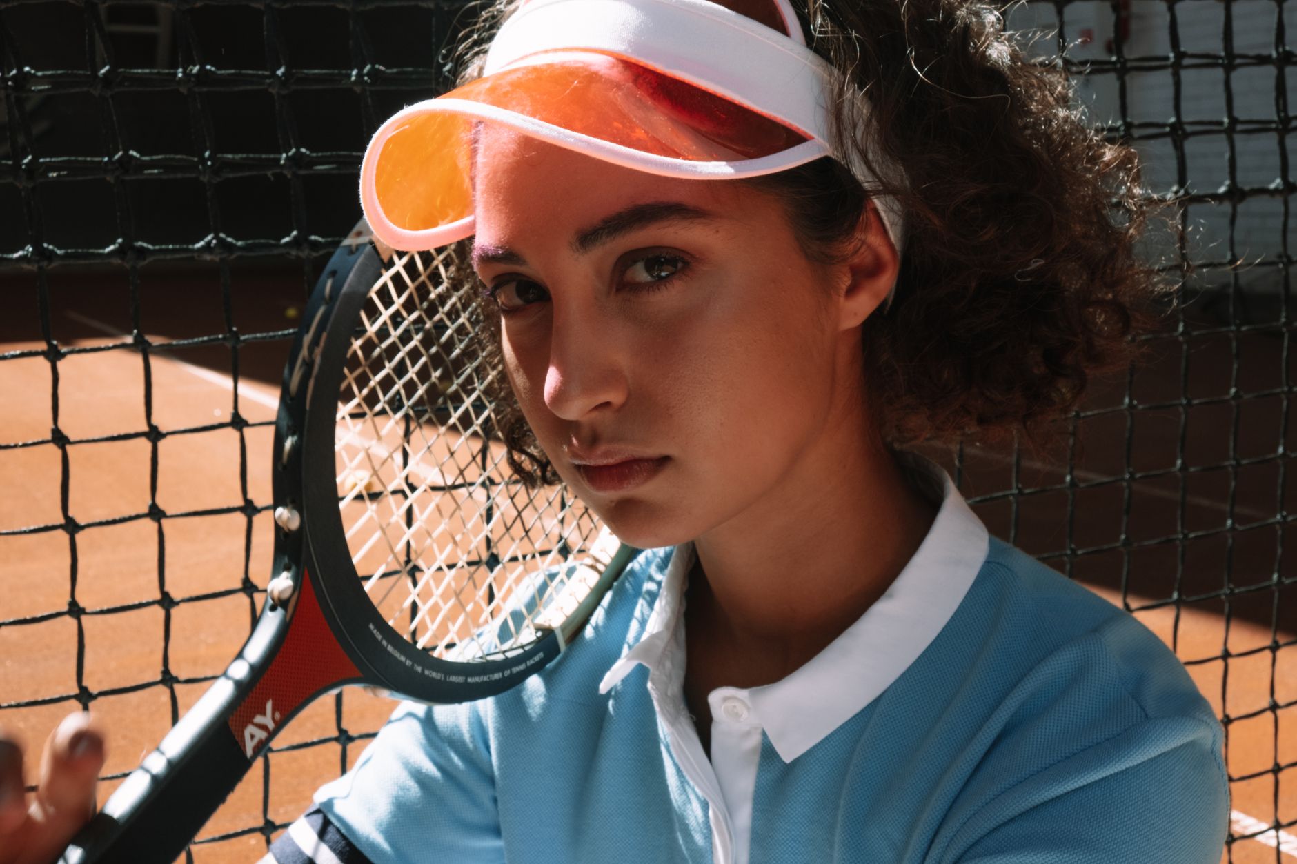 Woman wearing a structured sport visor with a precise, angular brim profile