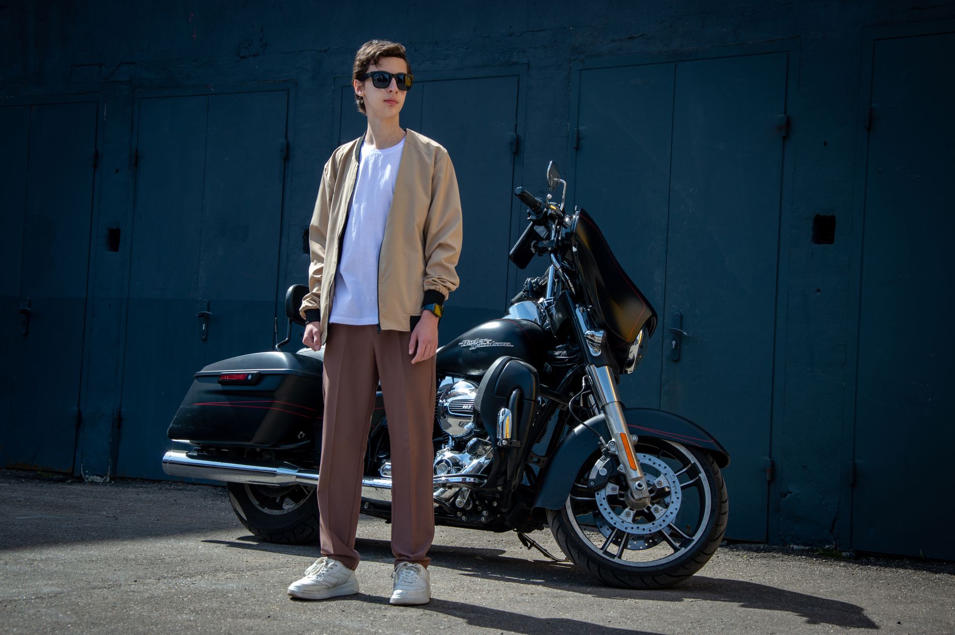 Close-up of minimalist wide-leg trousers with a narrow contrast hem band at the ankle