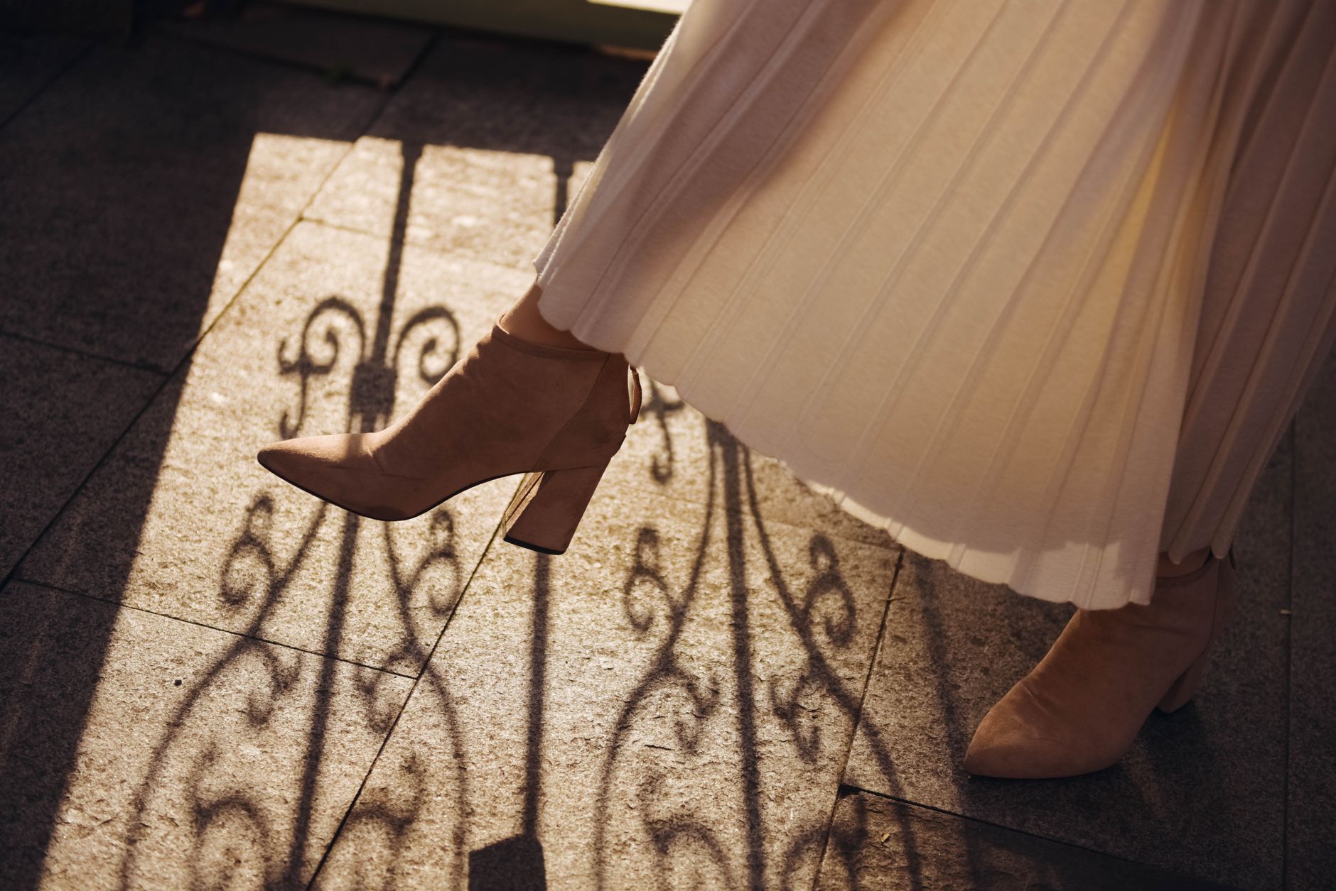 A tailored structured midi skirt with visible box pleats and a fitted silhouette