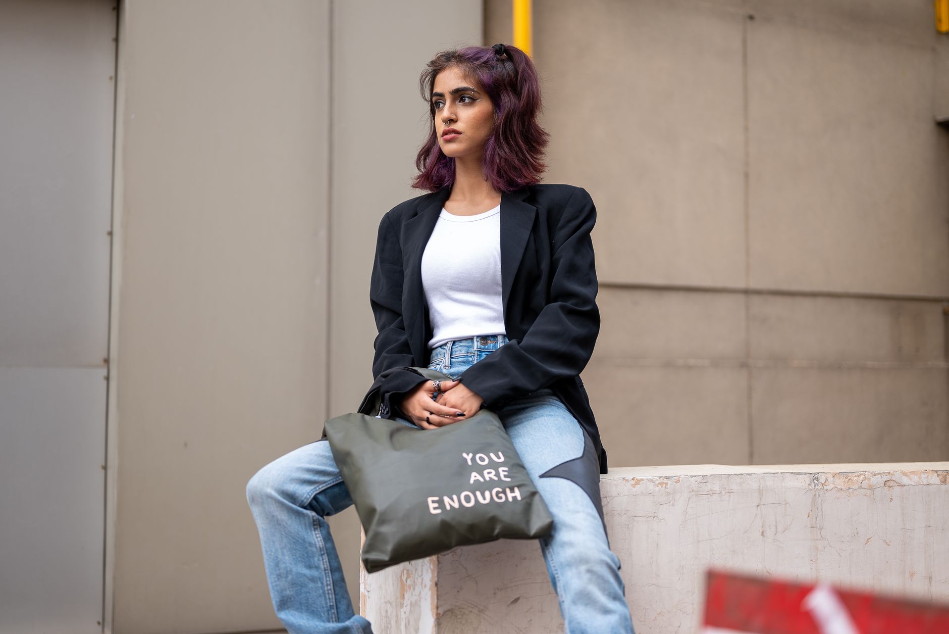 A structured leather and webbing tote bag with visible strap detail and hardware