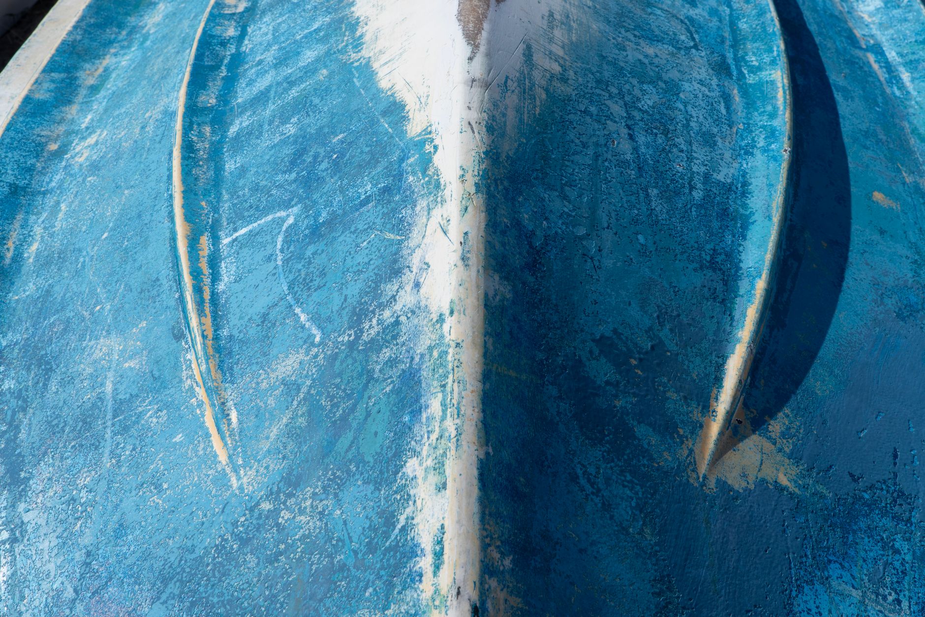 Detail of a rowing shell hull showing protective rubbing strip along the keel line