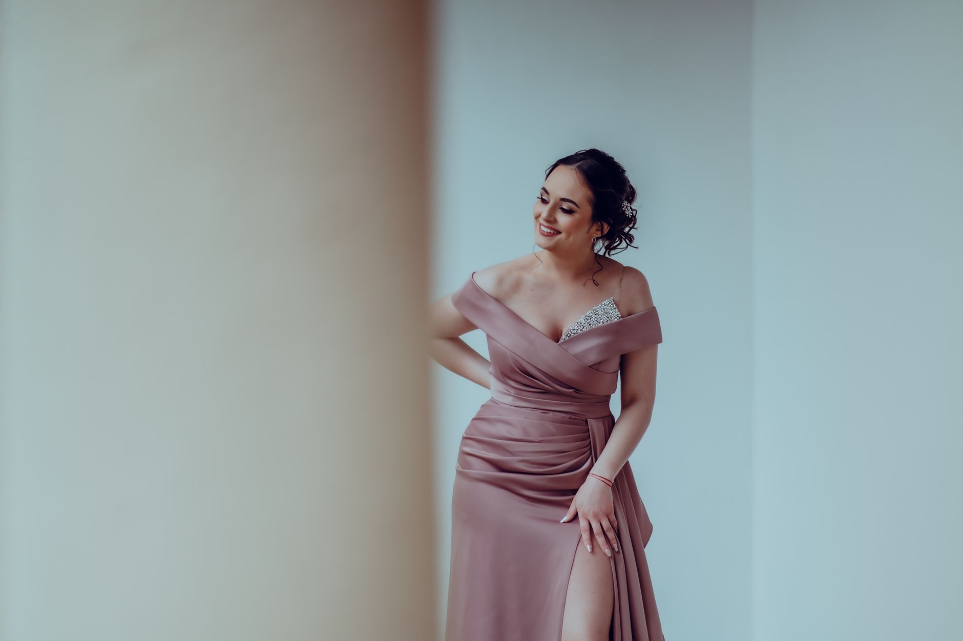 Structured strapless evening gown bodice in metallic fabric under formal lighting
