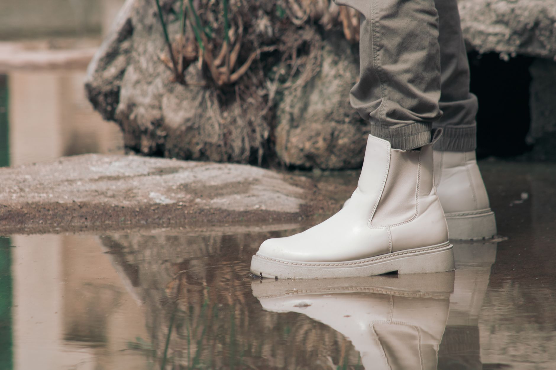 Styled outfit featuring structured dark boots with visible eyelet column and tailored trousers