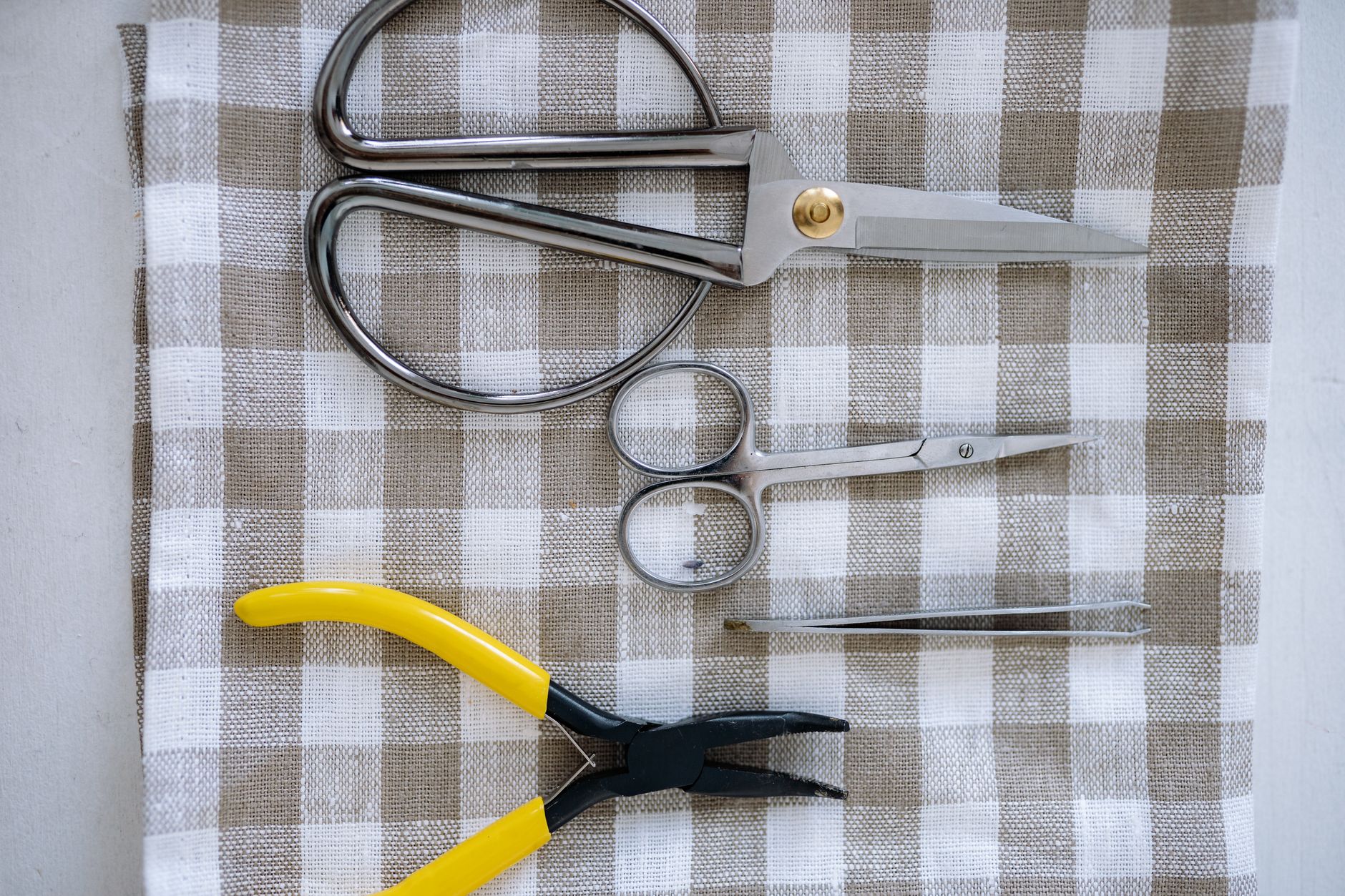 Assorted metal rings and hardware pieces laid out on a flat surface for jewelry design