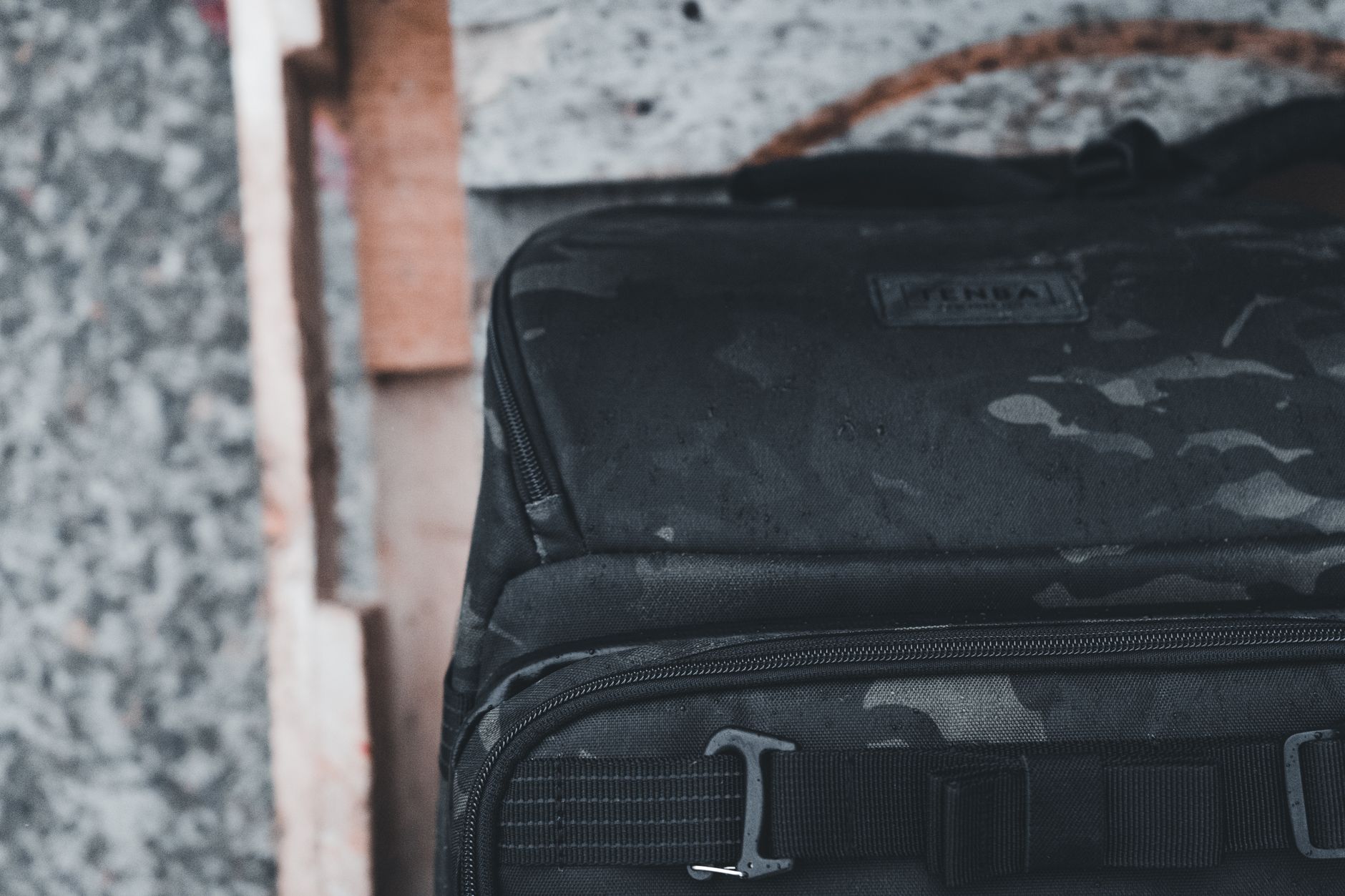 Detail shot of a wide woven strap with stripe pattern attached to a structured tote bag