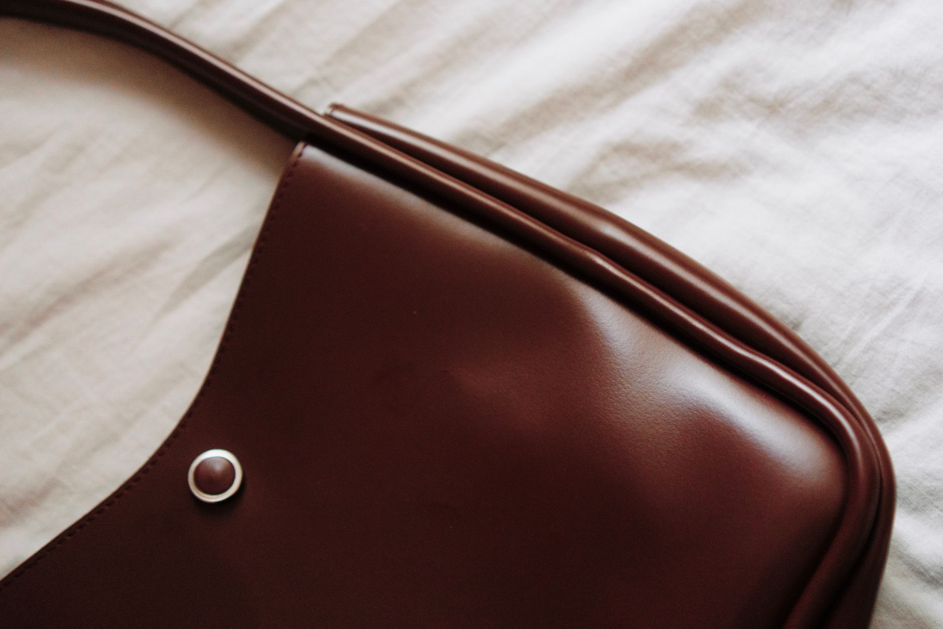 Detail shot of a tote bag base showing contrasting material trim and exterior edge construction