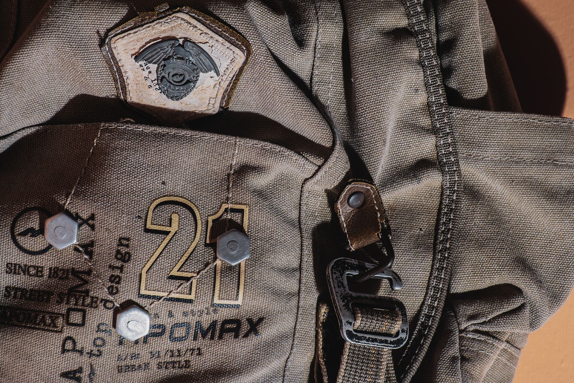 Detail shot of exterior base edging on a canvas tote bag showing raised strip construction