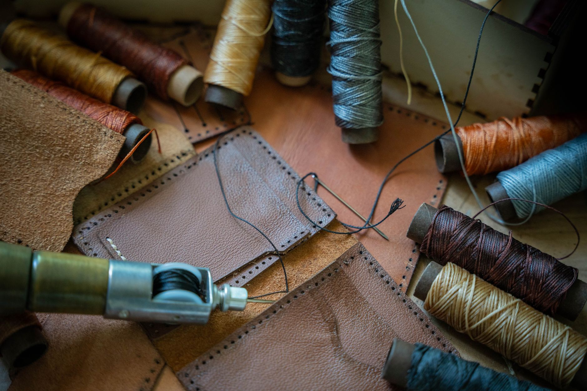 Leather working tools and raw hide material on a craftsman's bench