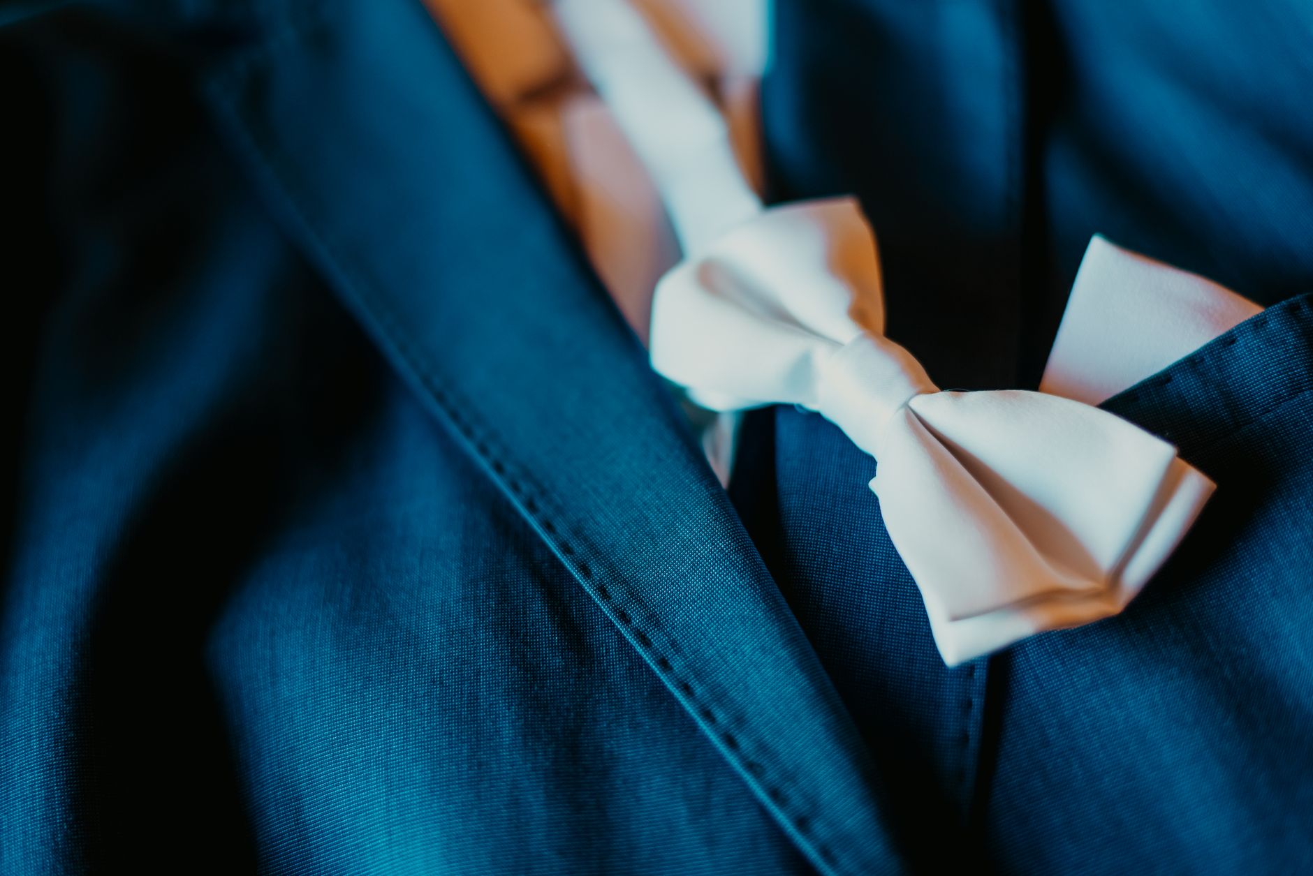 Detail shot of a formal jacket cuff with clustered buttons on a dressed figure